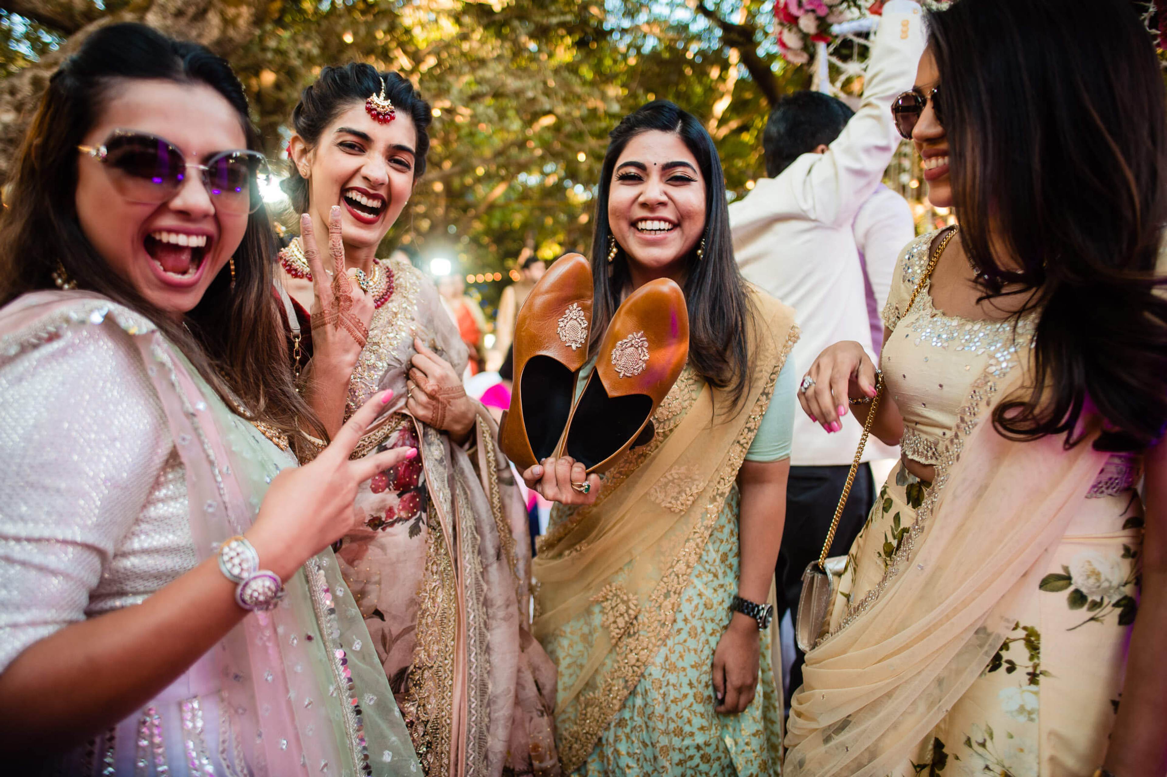 Four women in traditional Indian attire laughing and celebrating outdoors at Mahabaleshwar