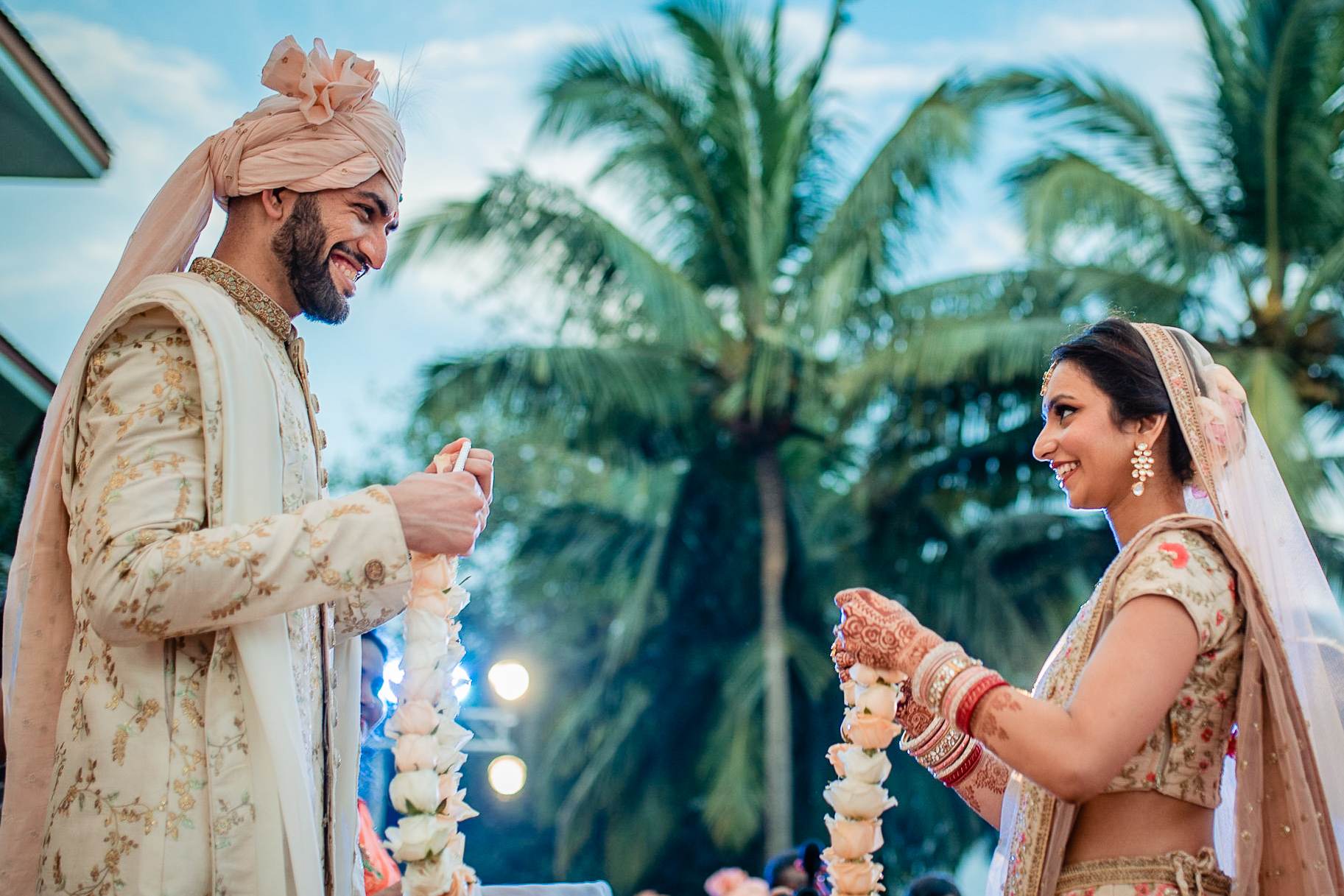 Avani and Srikant exchange garland vows under palm trees in Goa, tropical wedding ceremony