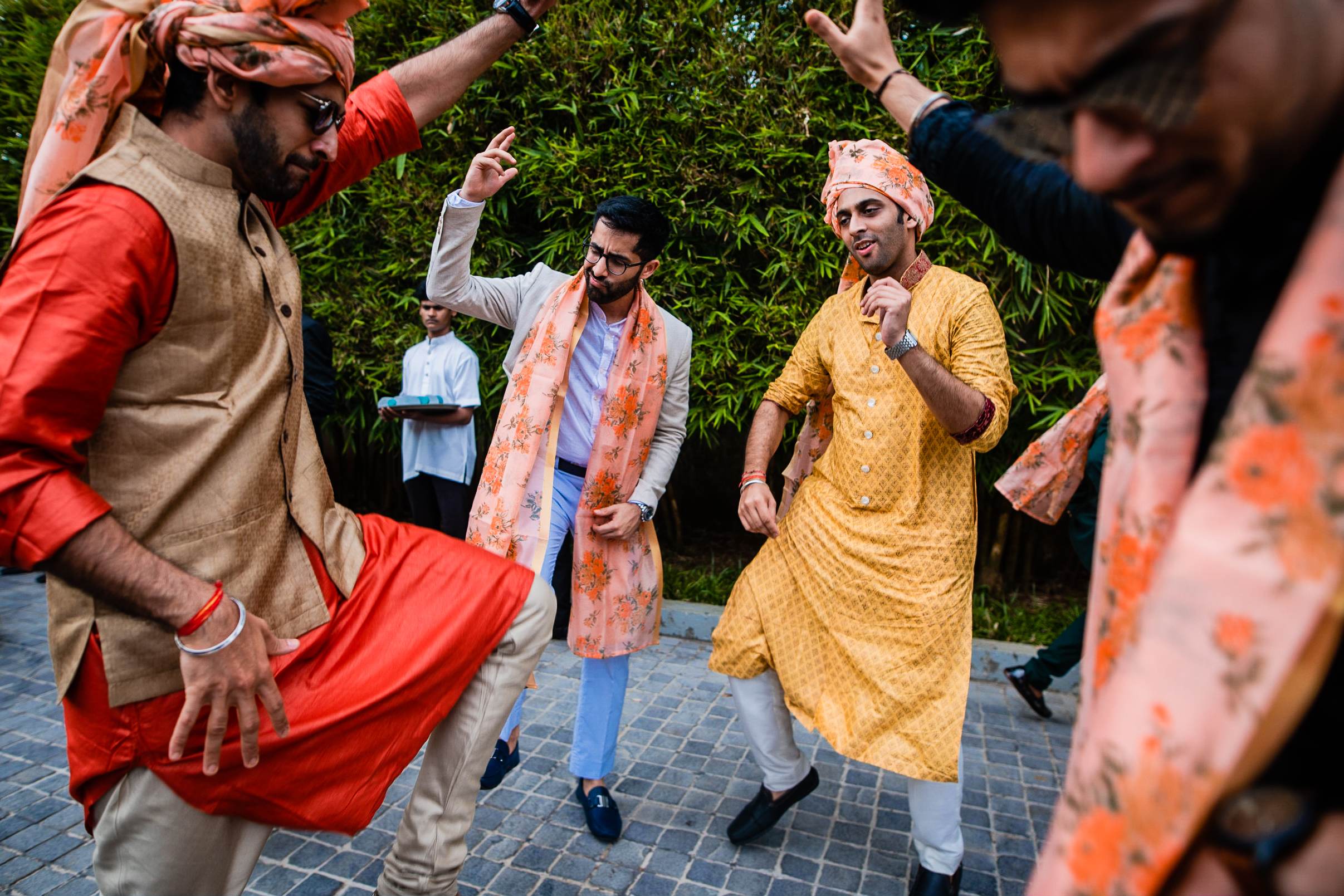 Avani & Srikant celebrate with guests in colorful traditional attire dancing outdoors in Goa