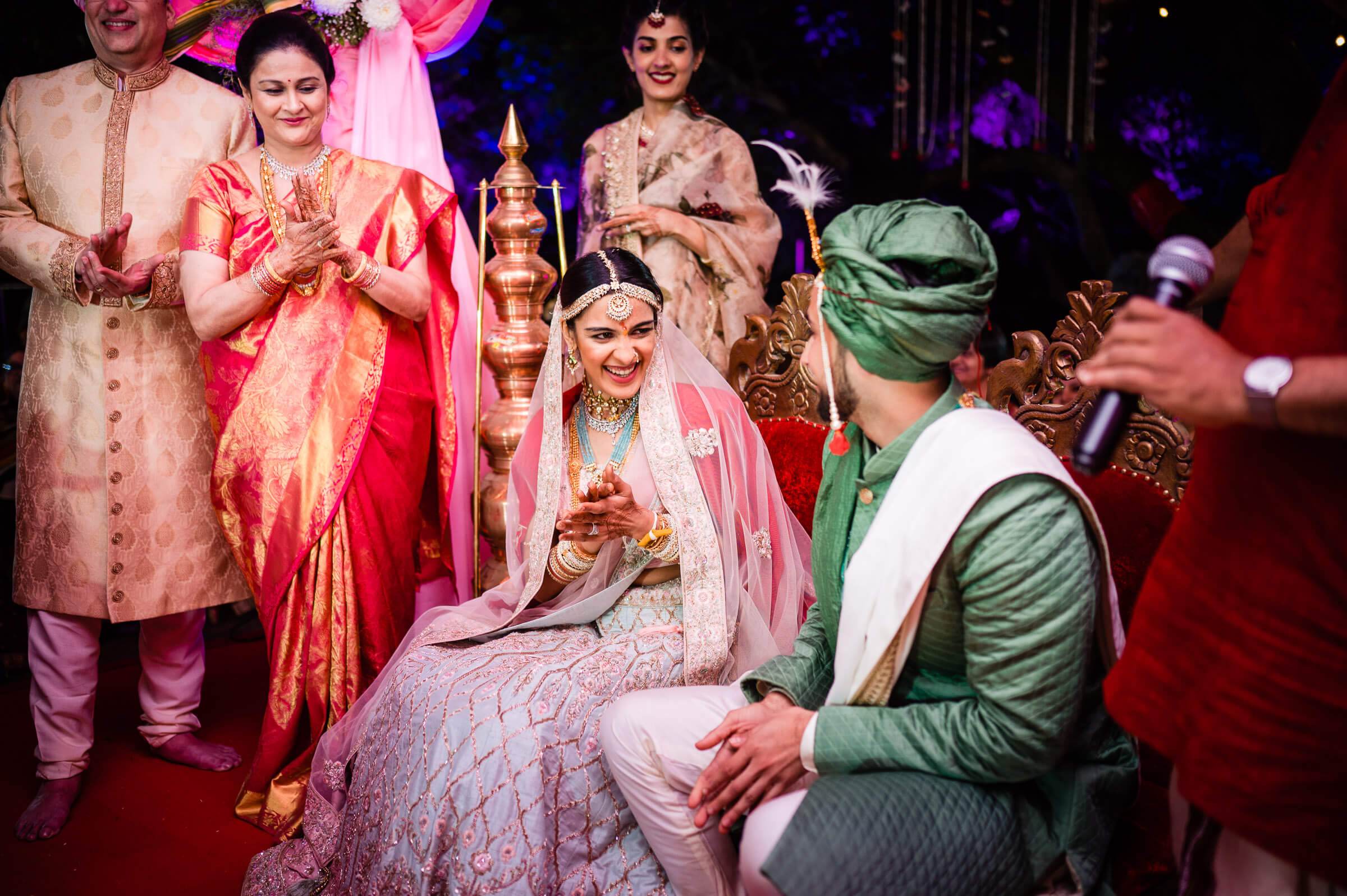 Shreya and Yash's wedding ceremony in Mahabaleshwar, couple in traditional attire surrounded by family and ornate gold décor