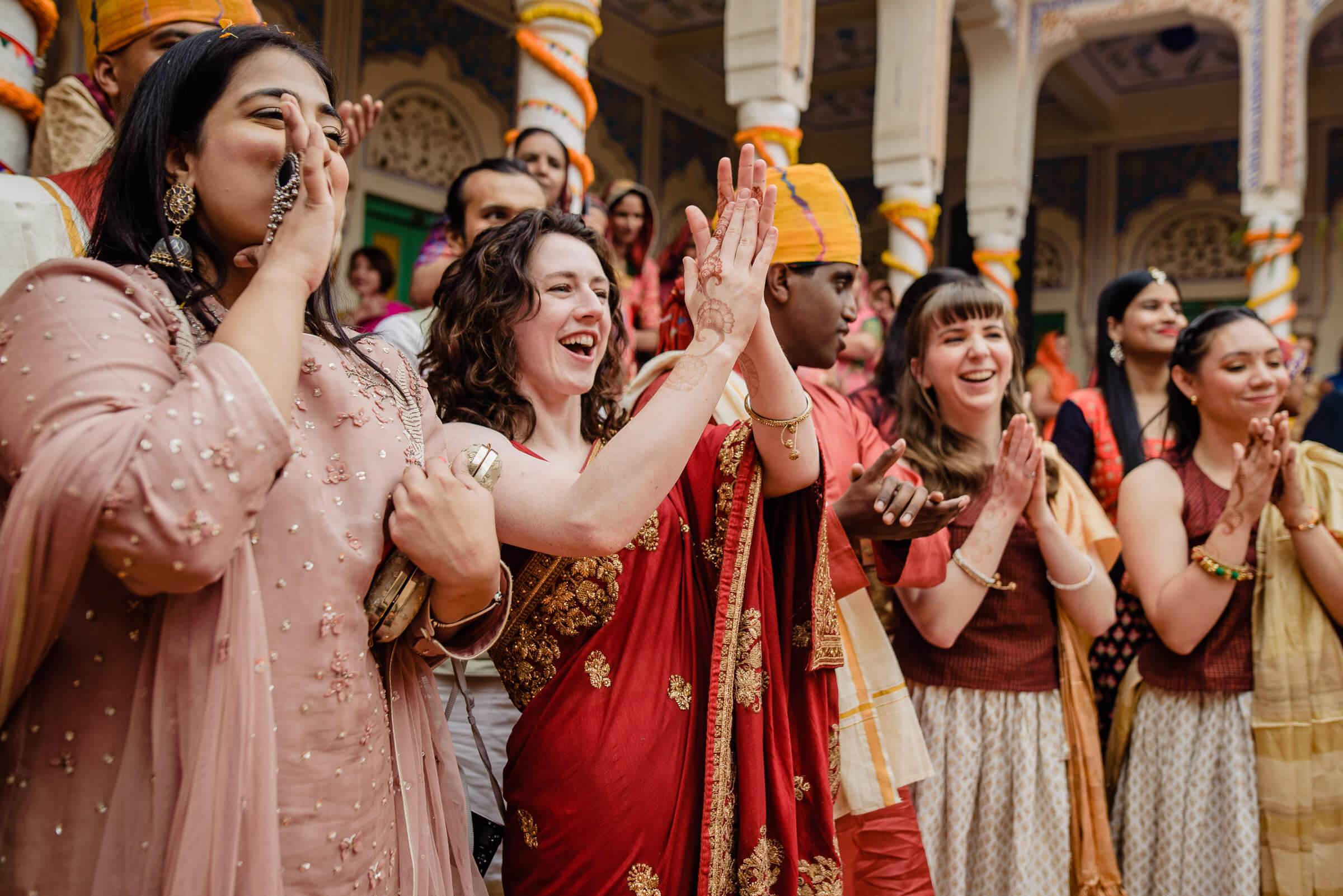 Maitrayee in red lehenga celebrates with guests in ornate Rajasthan palace during wedding festivities