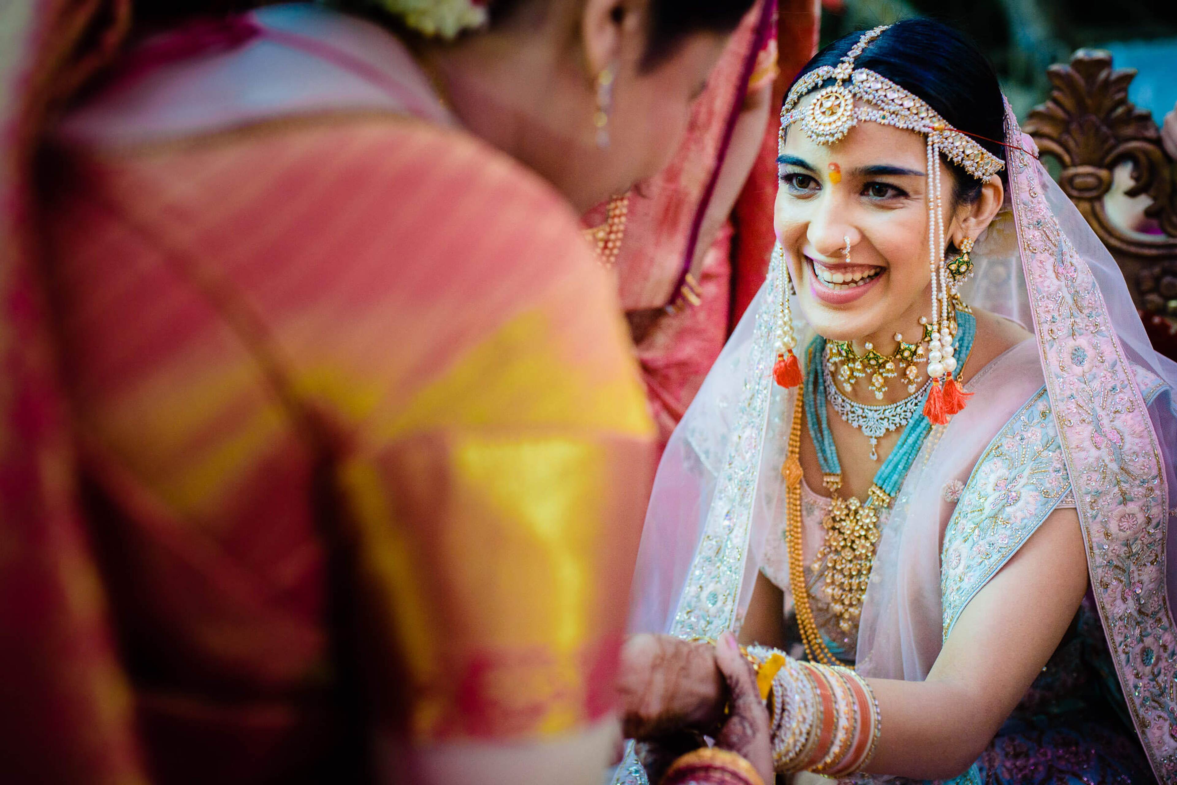 Shreya smiles in traditional bridal attire with jewelry and pink veil at Mahabaleshwar ceremony