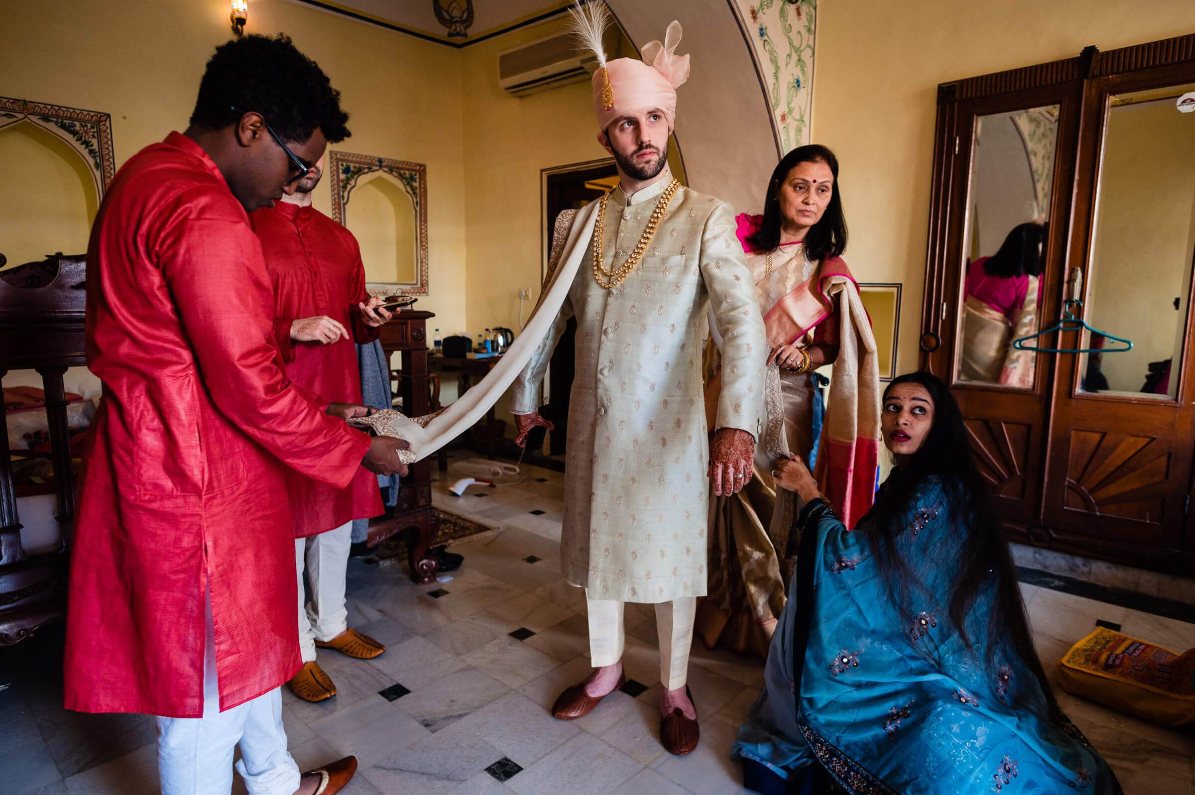 Maitrayee and Eric in traditional Rajasthani attire, getting ready with family in a mirrored dressing room