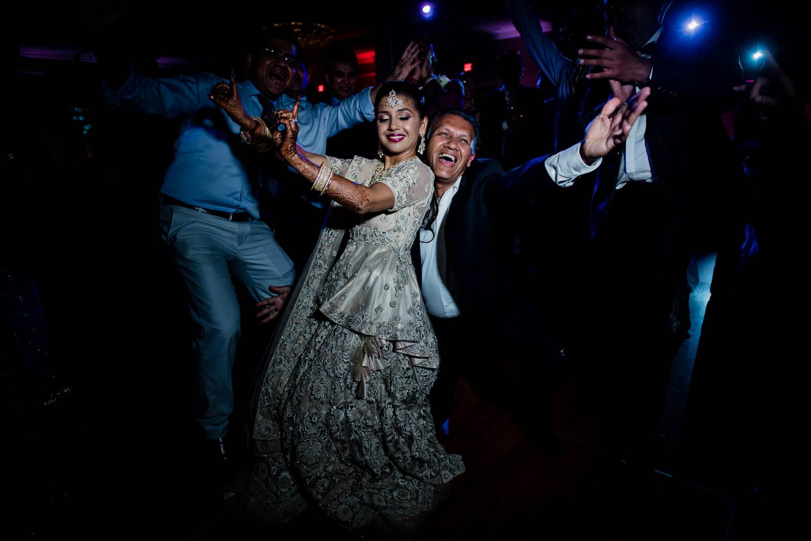 Barkha and Ankit celebrate on the dance floor surrounded by guests in New York