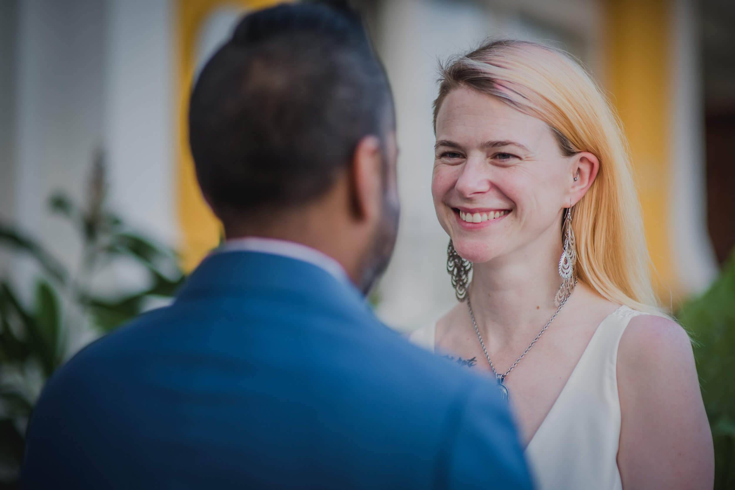 Sarah smiles at Ravin in a Goa courtyard with colonial architecture and plants behind them