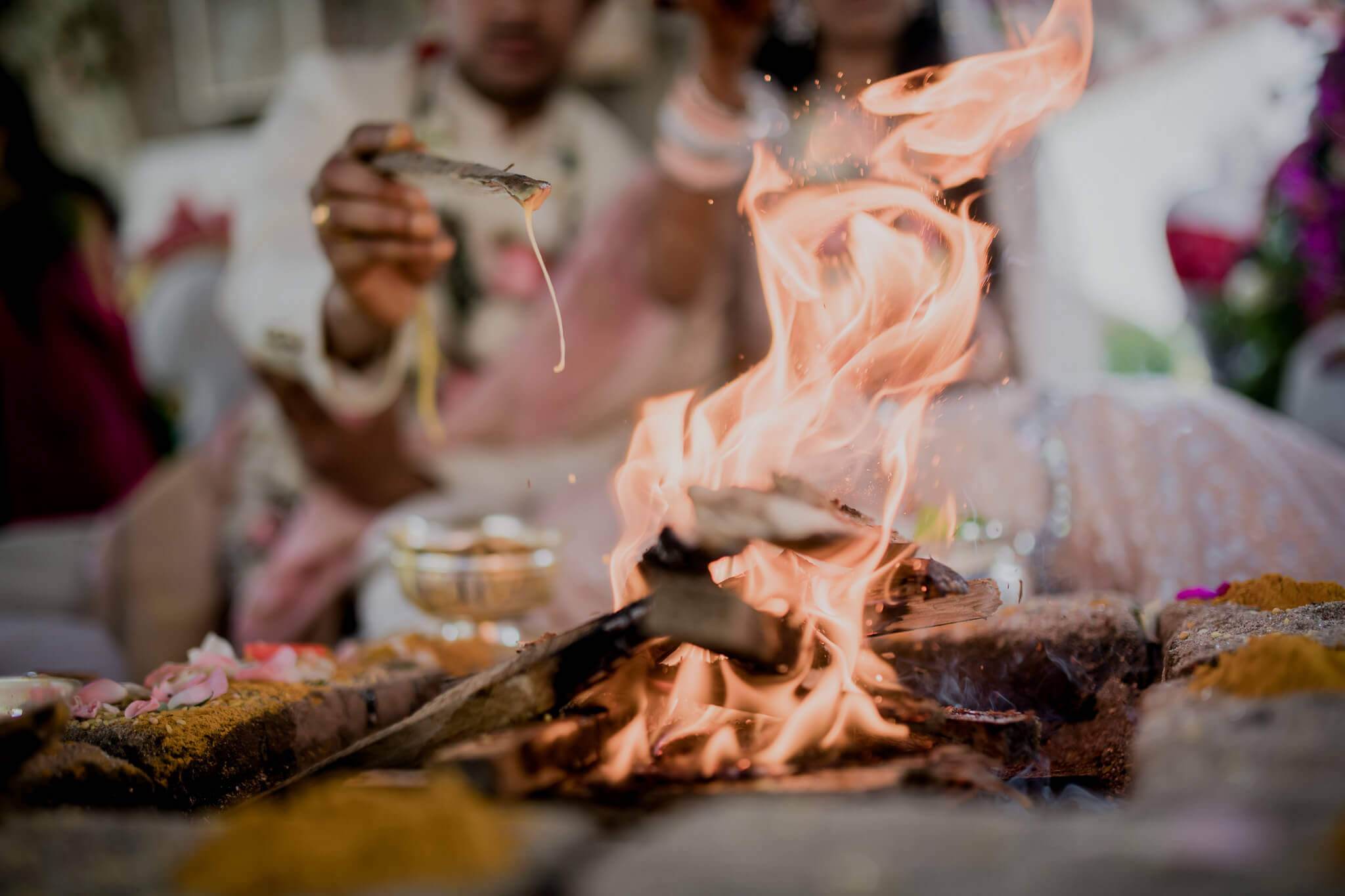 Anu & Raghu perform ritual at sacred fire during wedding ceremony in Nepal