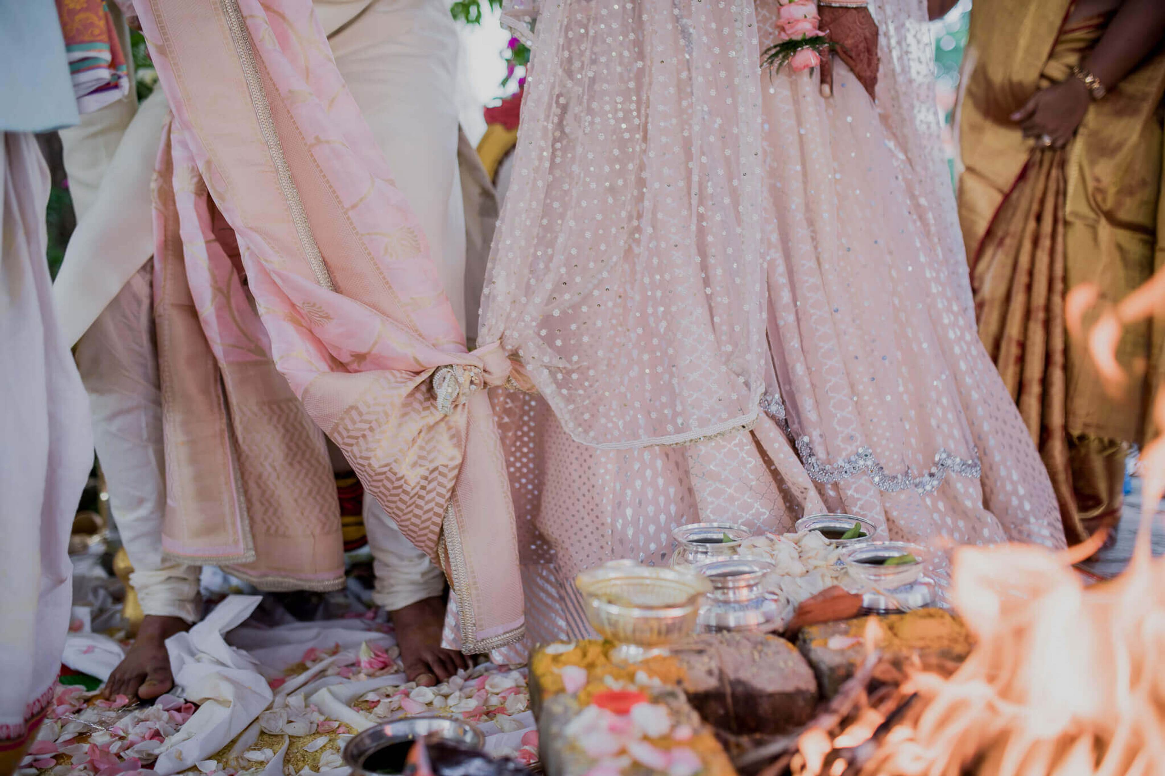 Anu and Raghu's wedding celebration in Nepal with traditional attire and festive food displayed