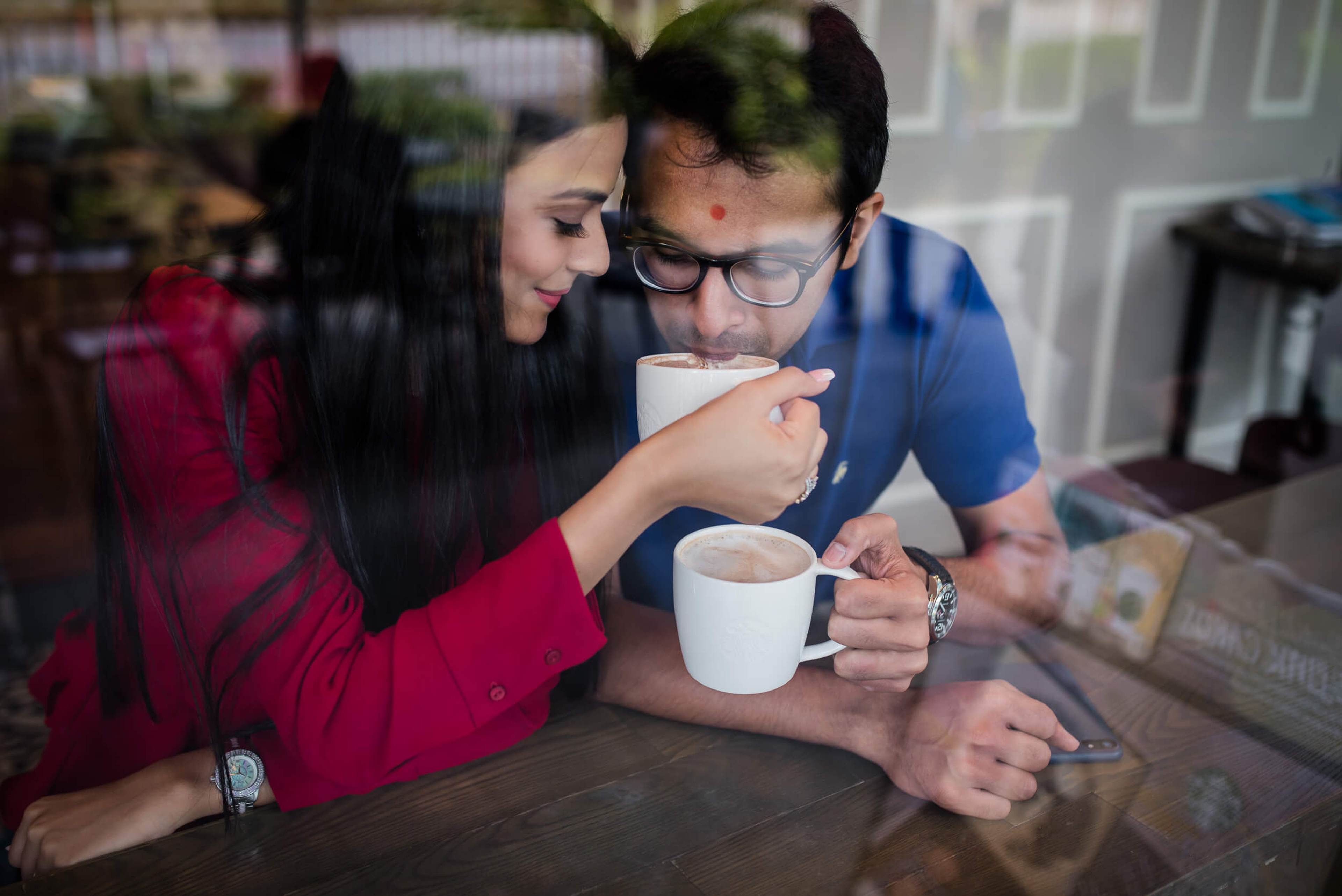 Yash and Disha share coffee at home in Singapore, smiling warmly in soft indoor light