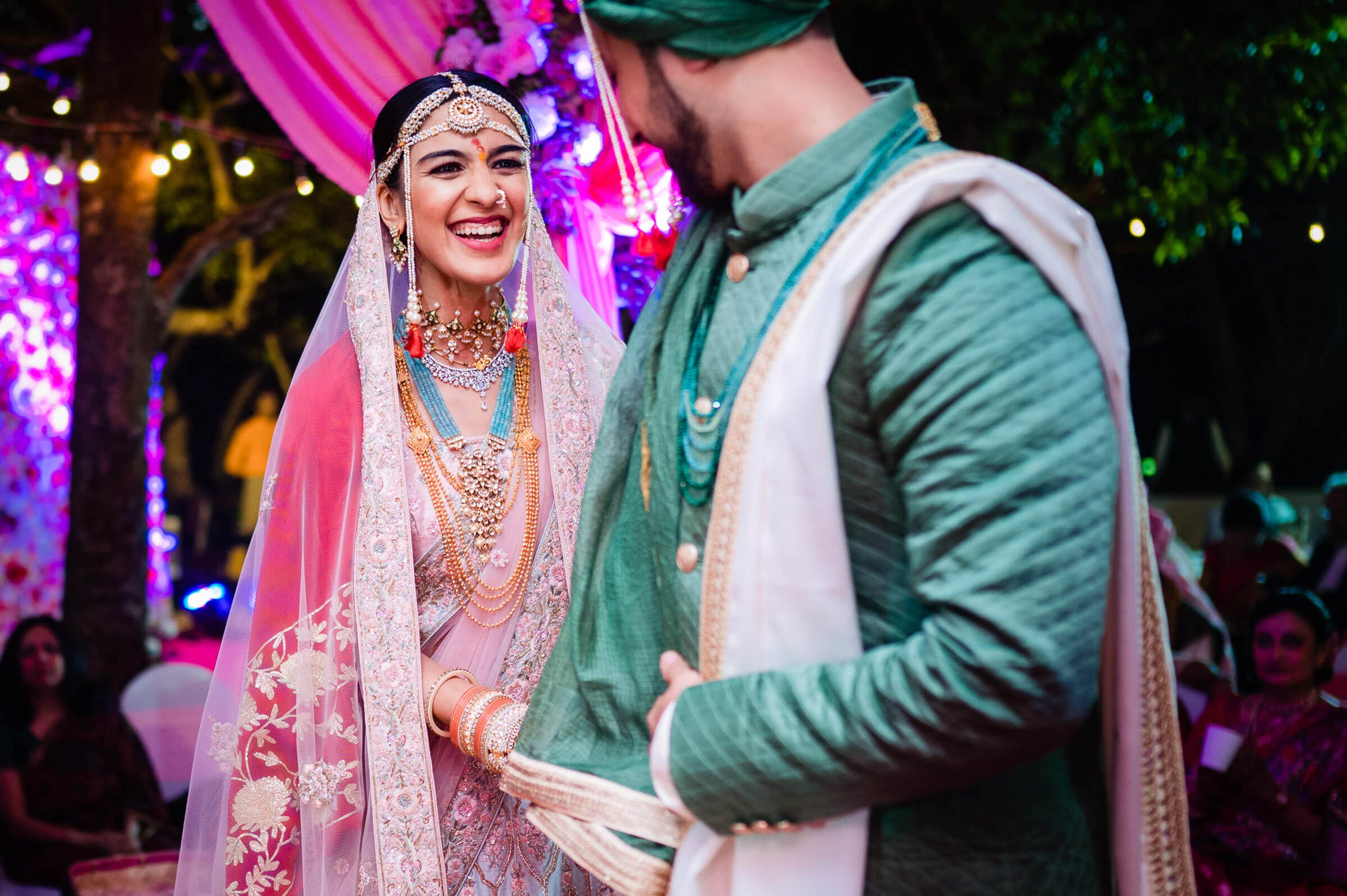Shreya and Yash exchange vows in traditional attire under vibrant purple lighting at Mahabaleshwar