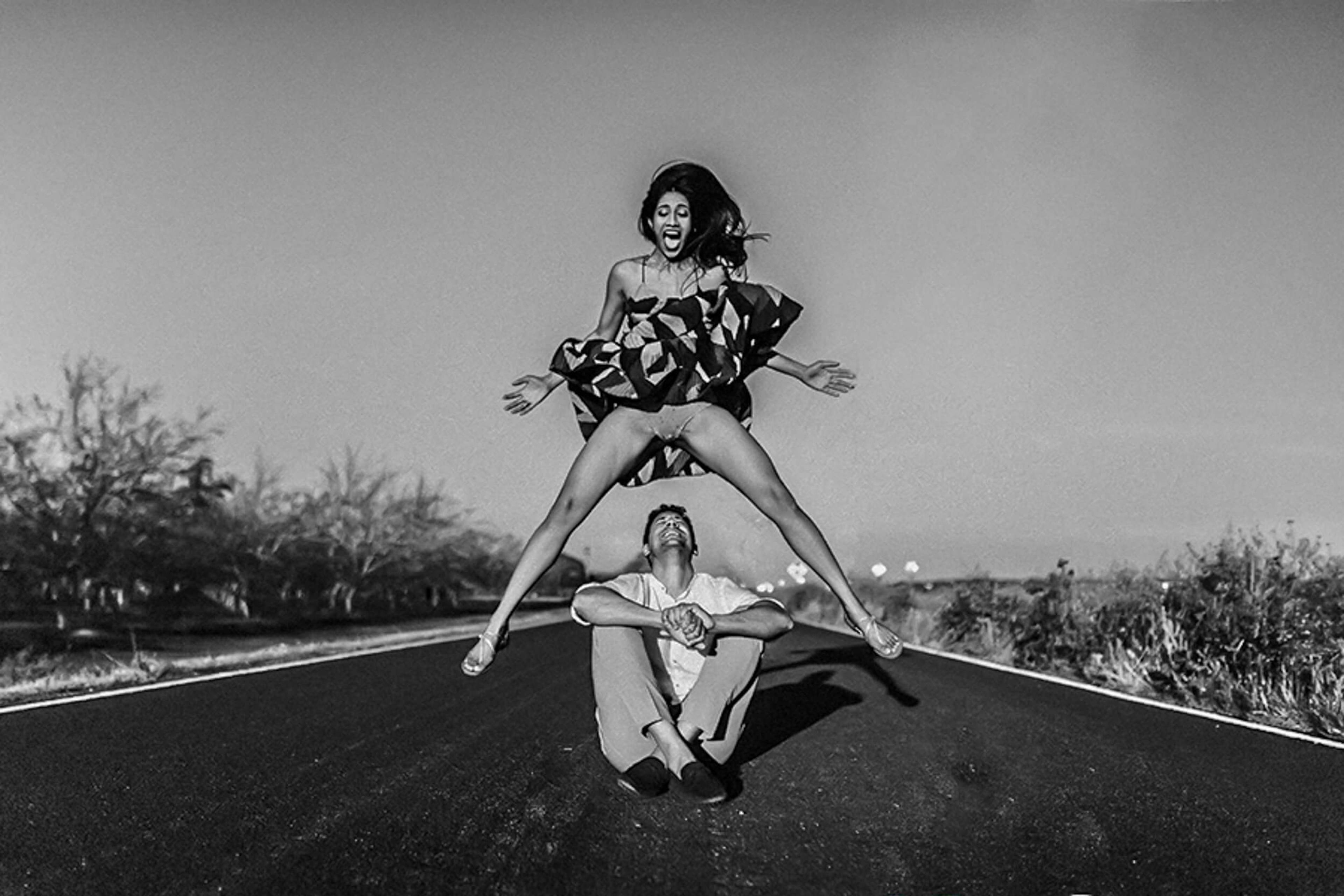 Anu and Raghu pose playfully on a California desert road in black and white