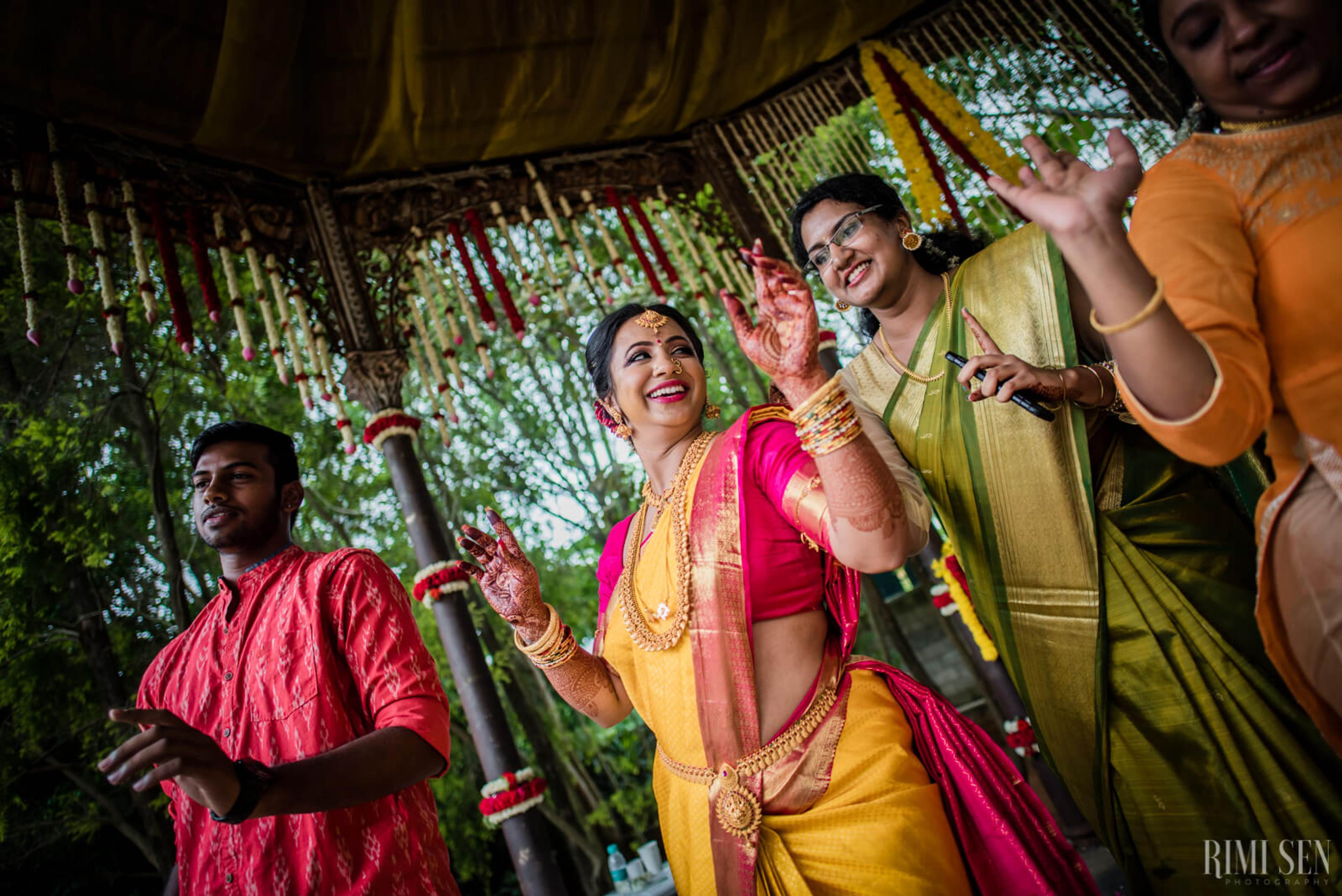 Nivetha and Sridhar celebrate under a decorated canopy in traditional attire during their Bangalore wedding
