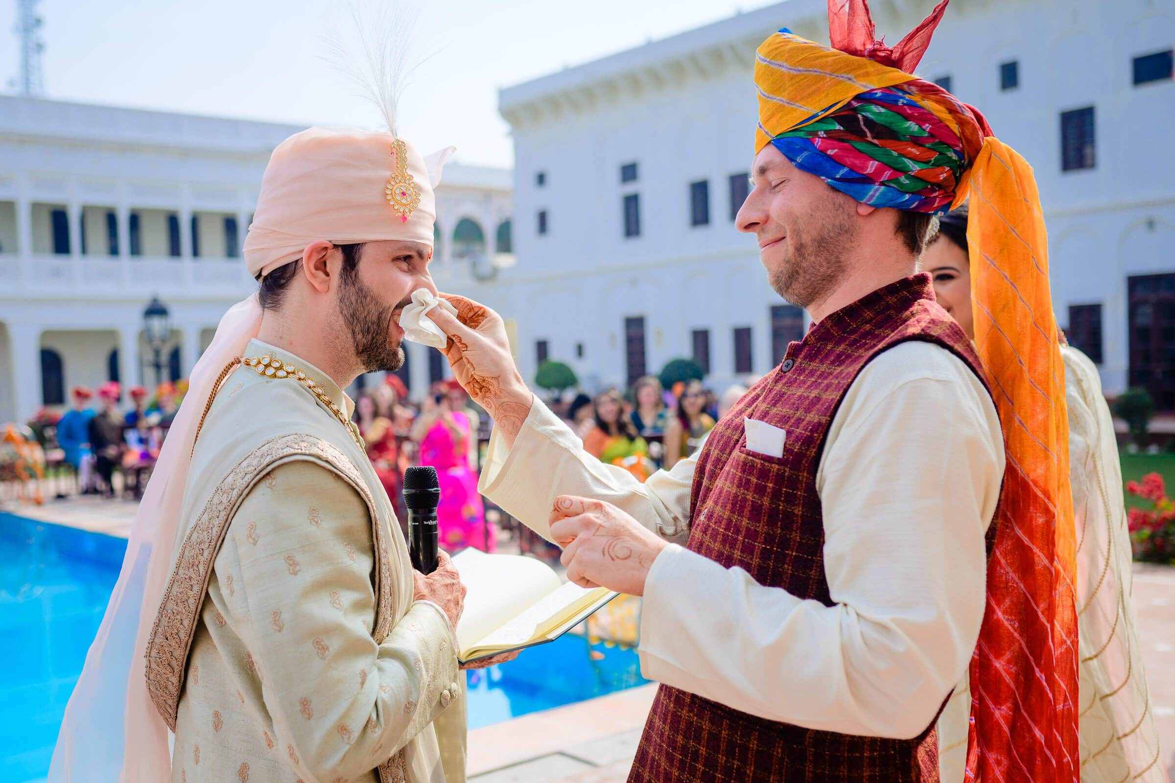 Maitrayee and Eric share food during a colorful Rajasthan wedding celebration in a courtyard