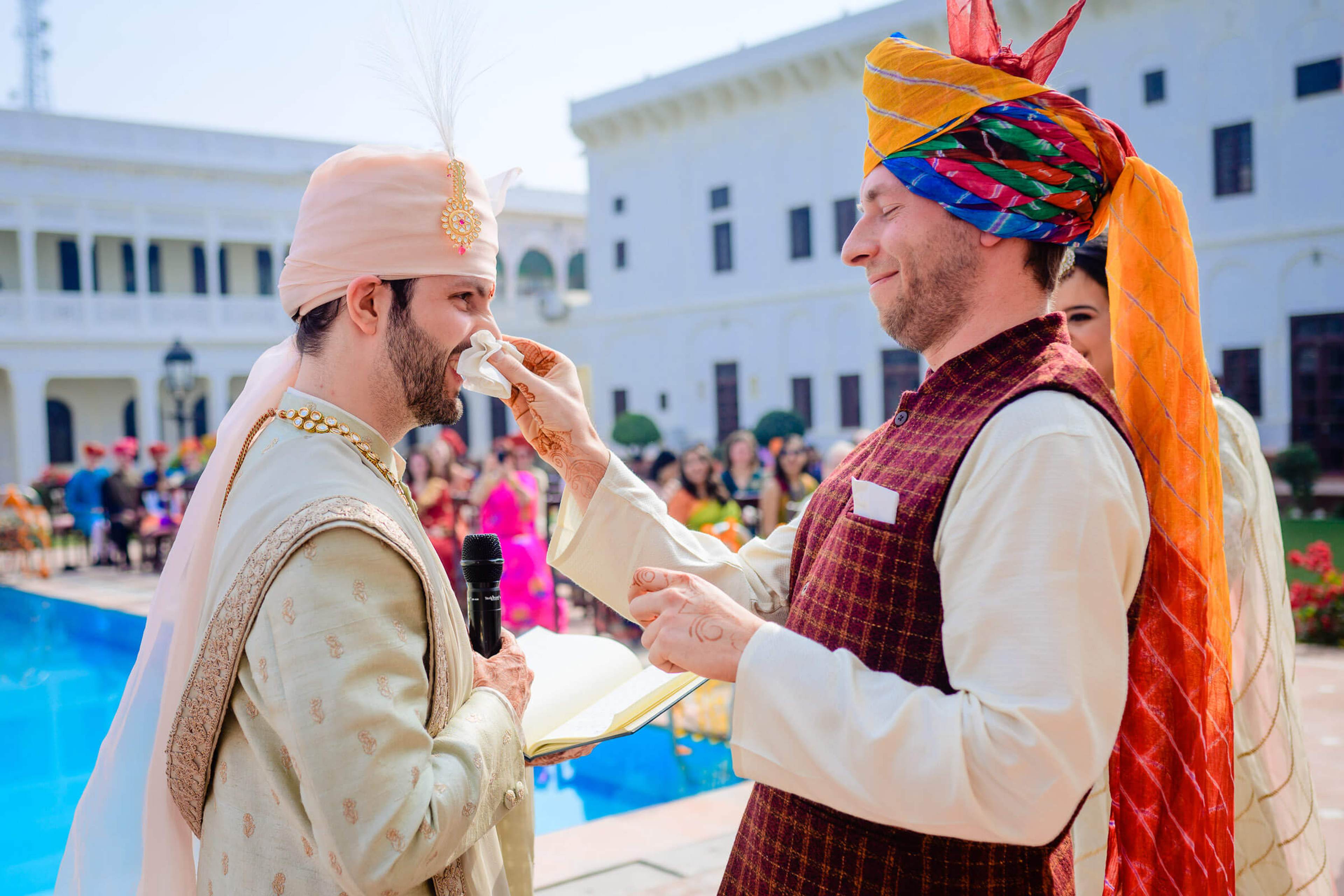Maitrayee and Eric share food during a colorful Rajasthan wedding celebration in a courtyard
