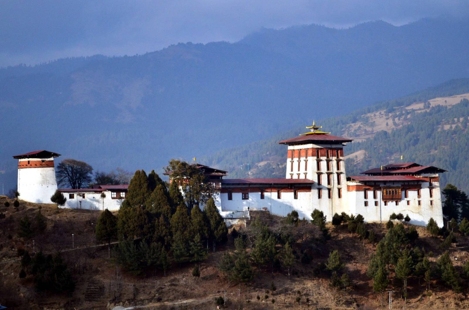Jakar Dzong's white walls and tall central tower on a ridge above the Bumthang valley