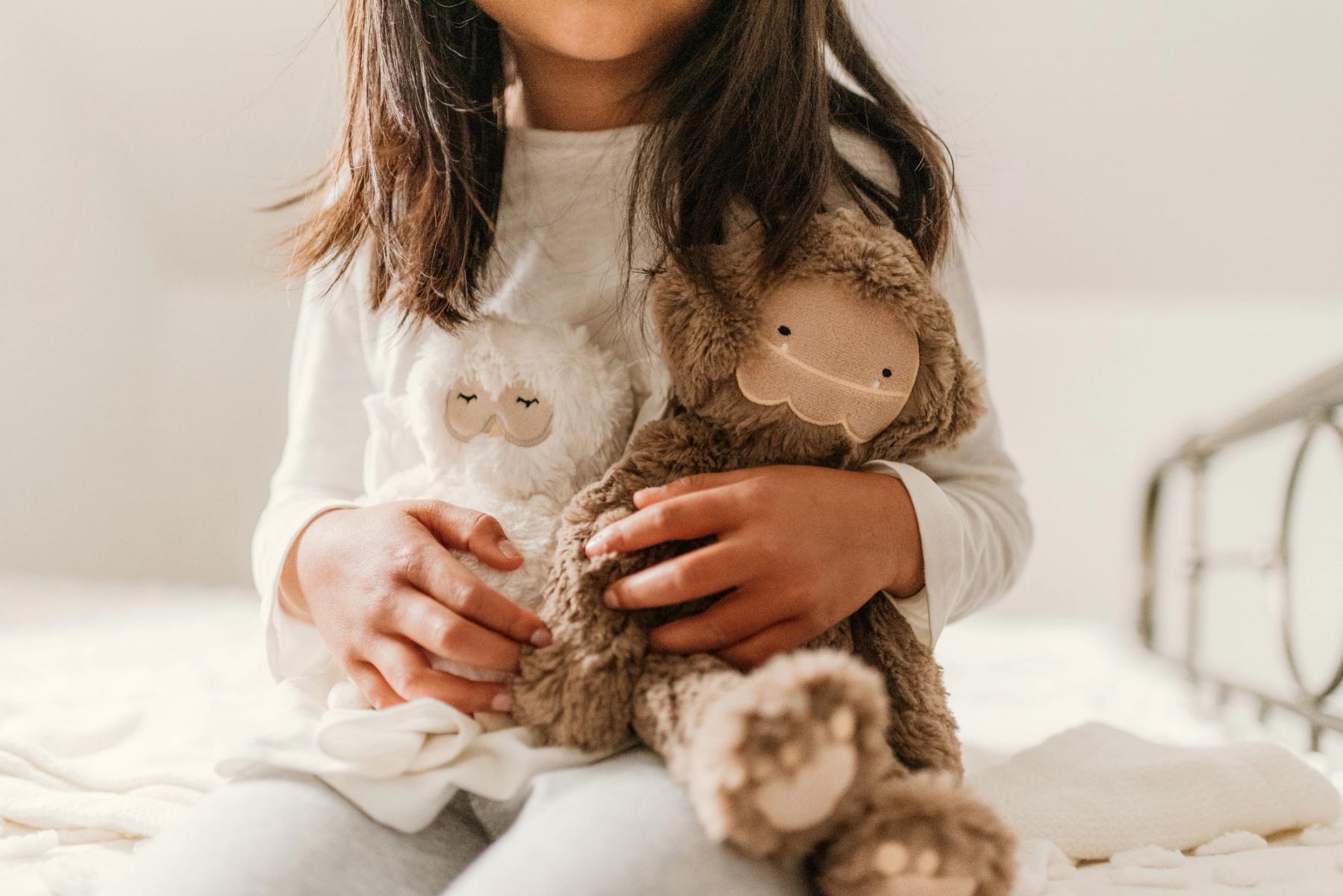 Child holding two slumberkins