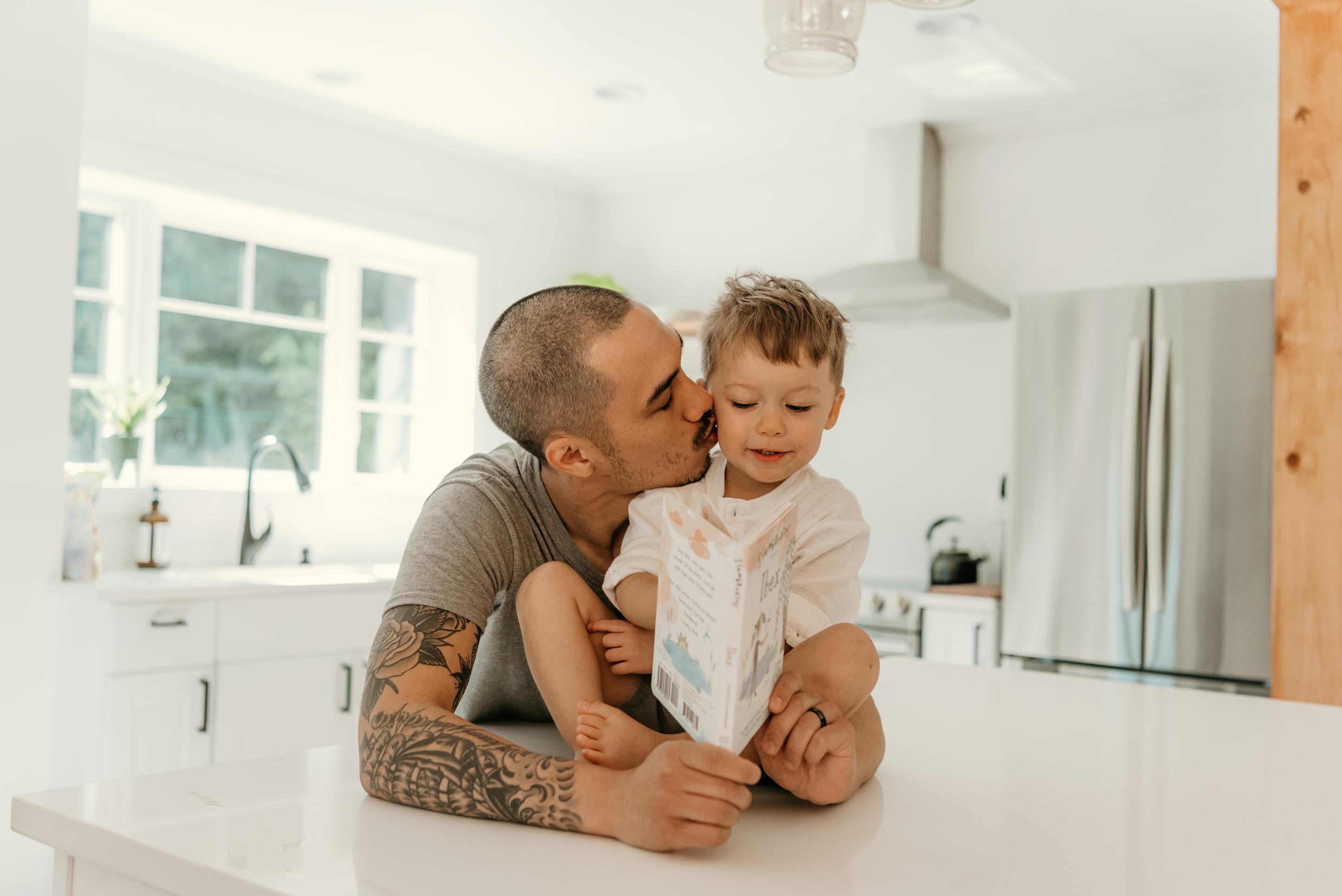 Man reading slumberkins book to a child