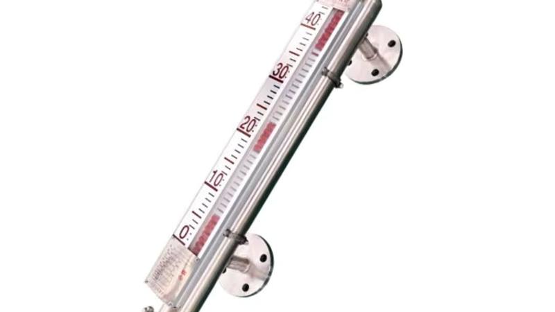 Anti-corrosion PTFE-lined magnetic level gauge with flanged process connections and a side-mounted magnetic indicator installed on a chemical storage tank, showing the 316L chamber body with white PTFE lining and a remote 4-20 mA transmitter.