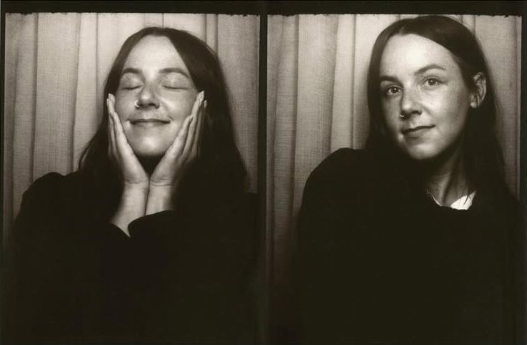 Accessibility Alt Text: Black and white photobooth portraits of a woman with long dark hair, smiling softly in one frame and gently holding her face with both hands in the other. SEO Caption: Portrait diptych — intimate black-and-white photobooth self-portrait capturing quiet expression and natural warmth.