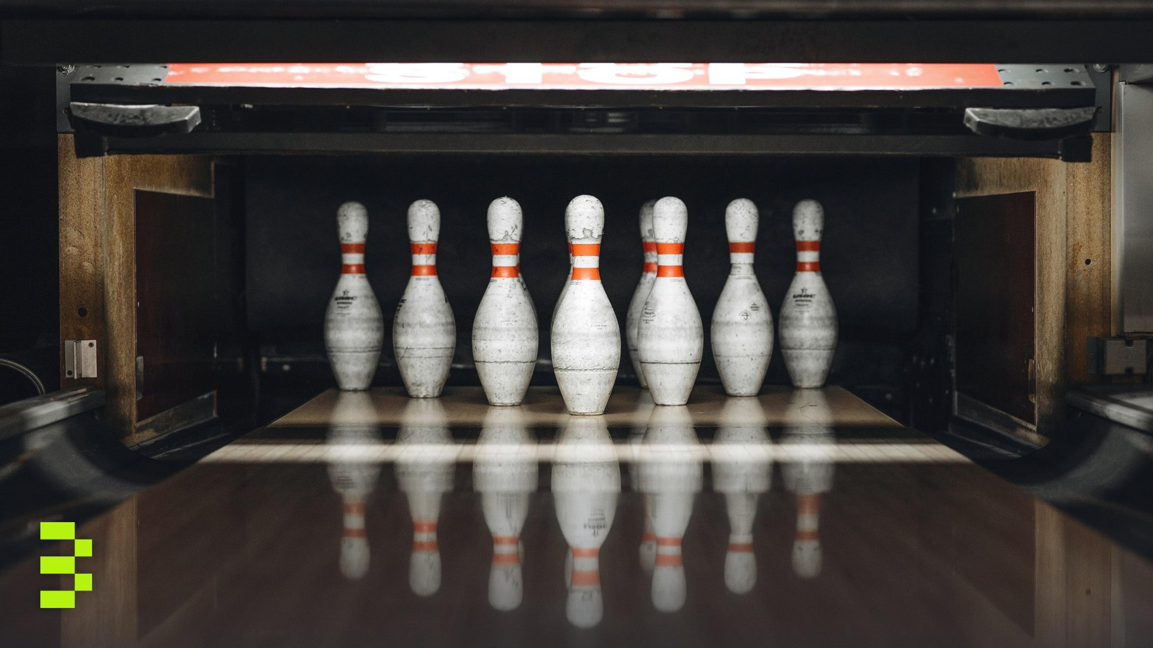 Seven bowling pins arranged in an alley, ready for a game.