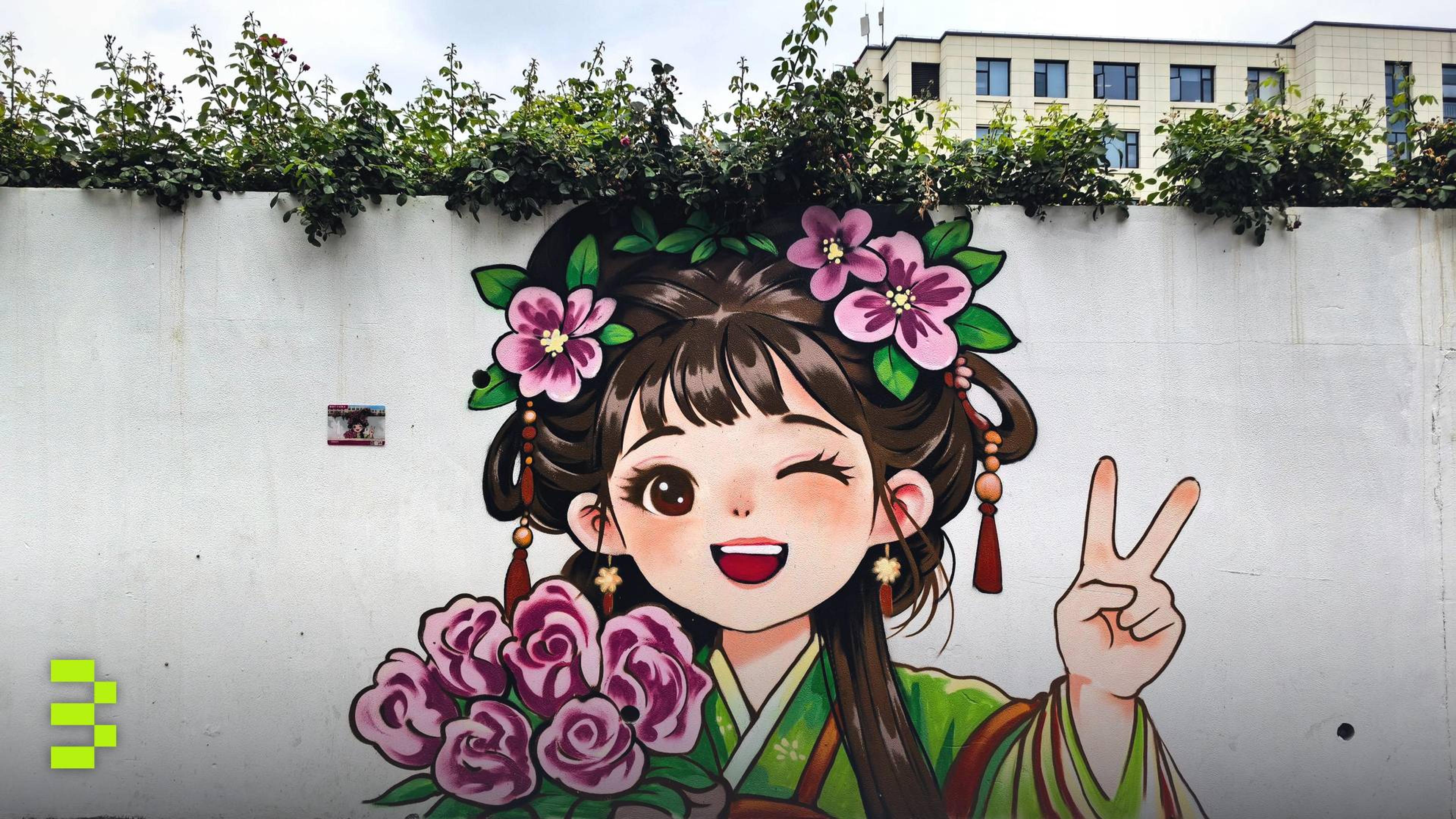 Colorful anime-style mural of a girl with flowers making a peace sign on a city wall.