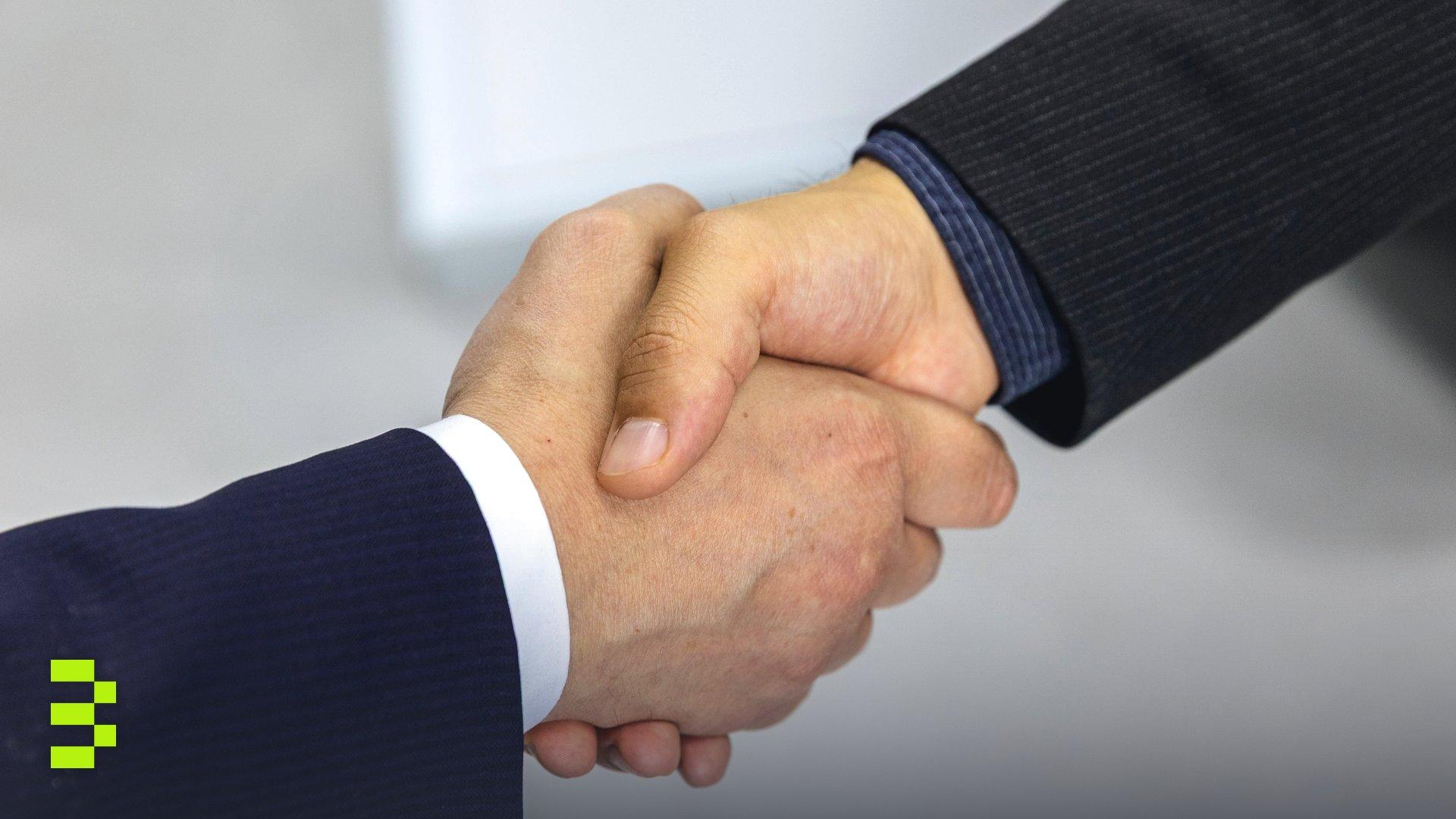 Close-up of two businessmen shaking hands.