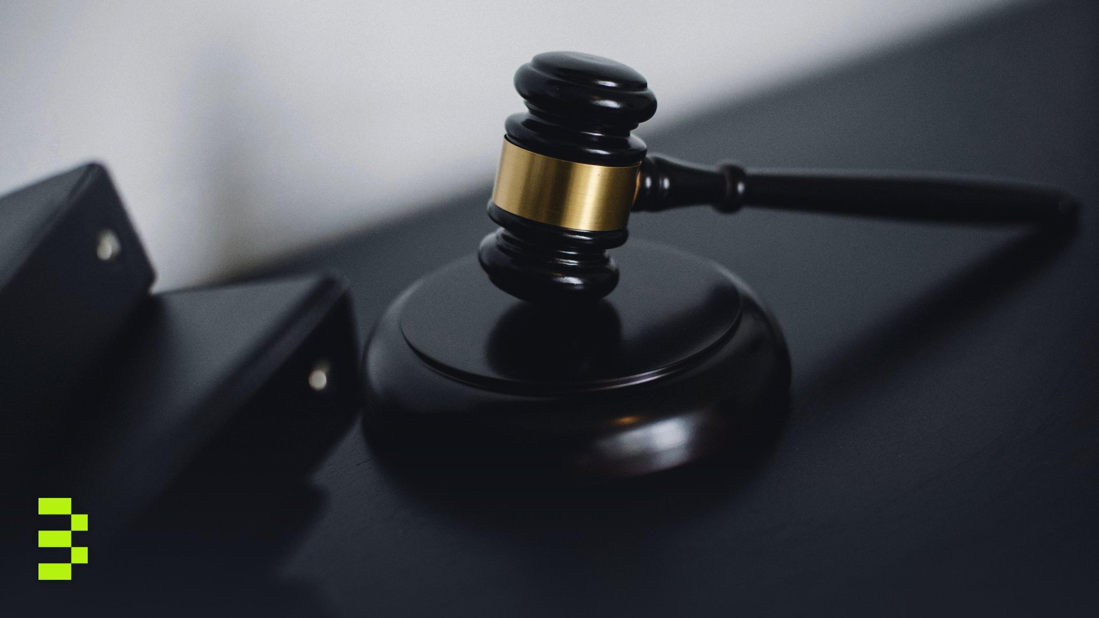 Close-up of a wooden gavel on a desk.