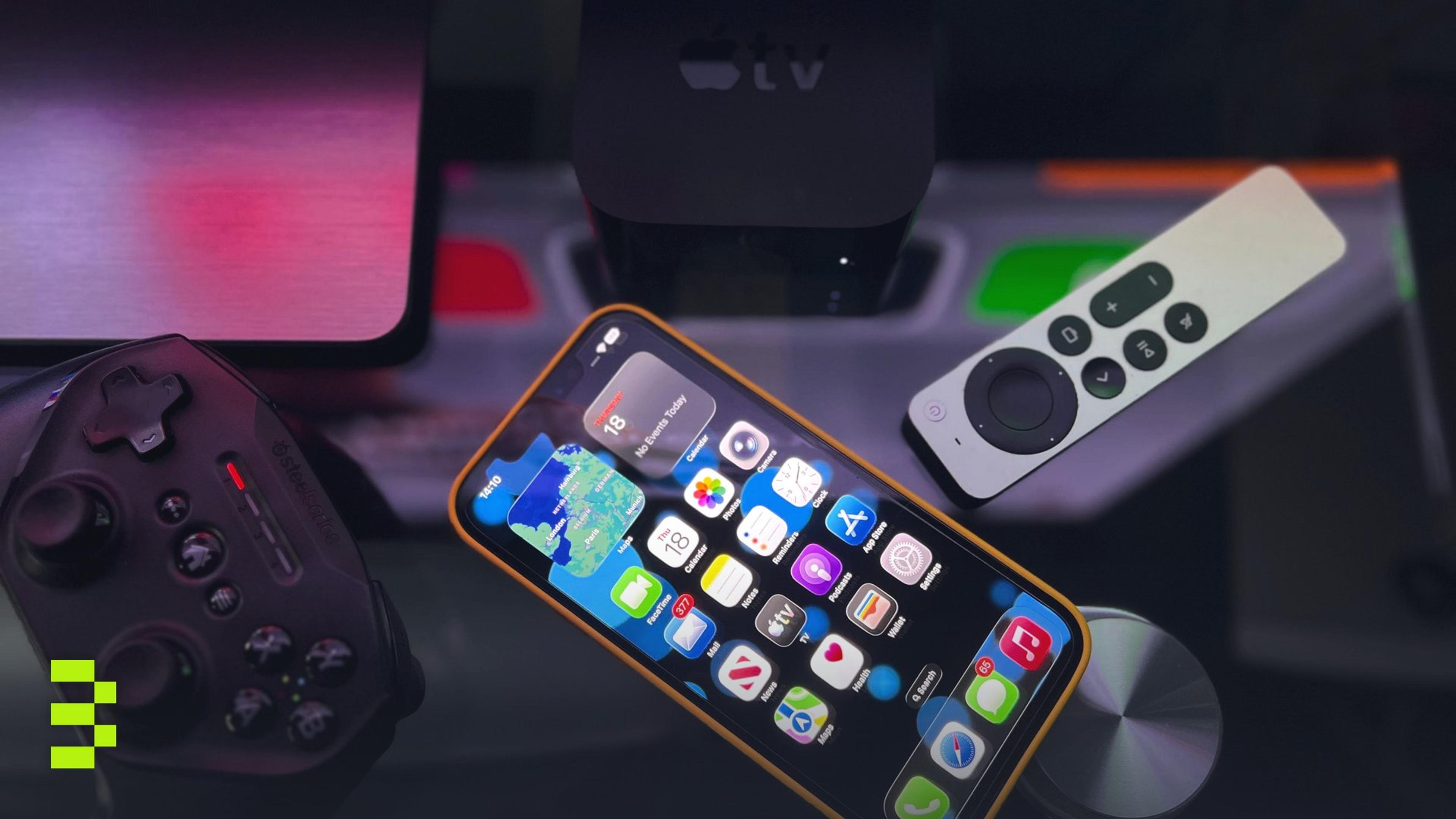 Stylish home entertainment setup featuring an iPhone, Apple TV, and gaming controller on a dark surface.
