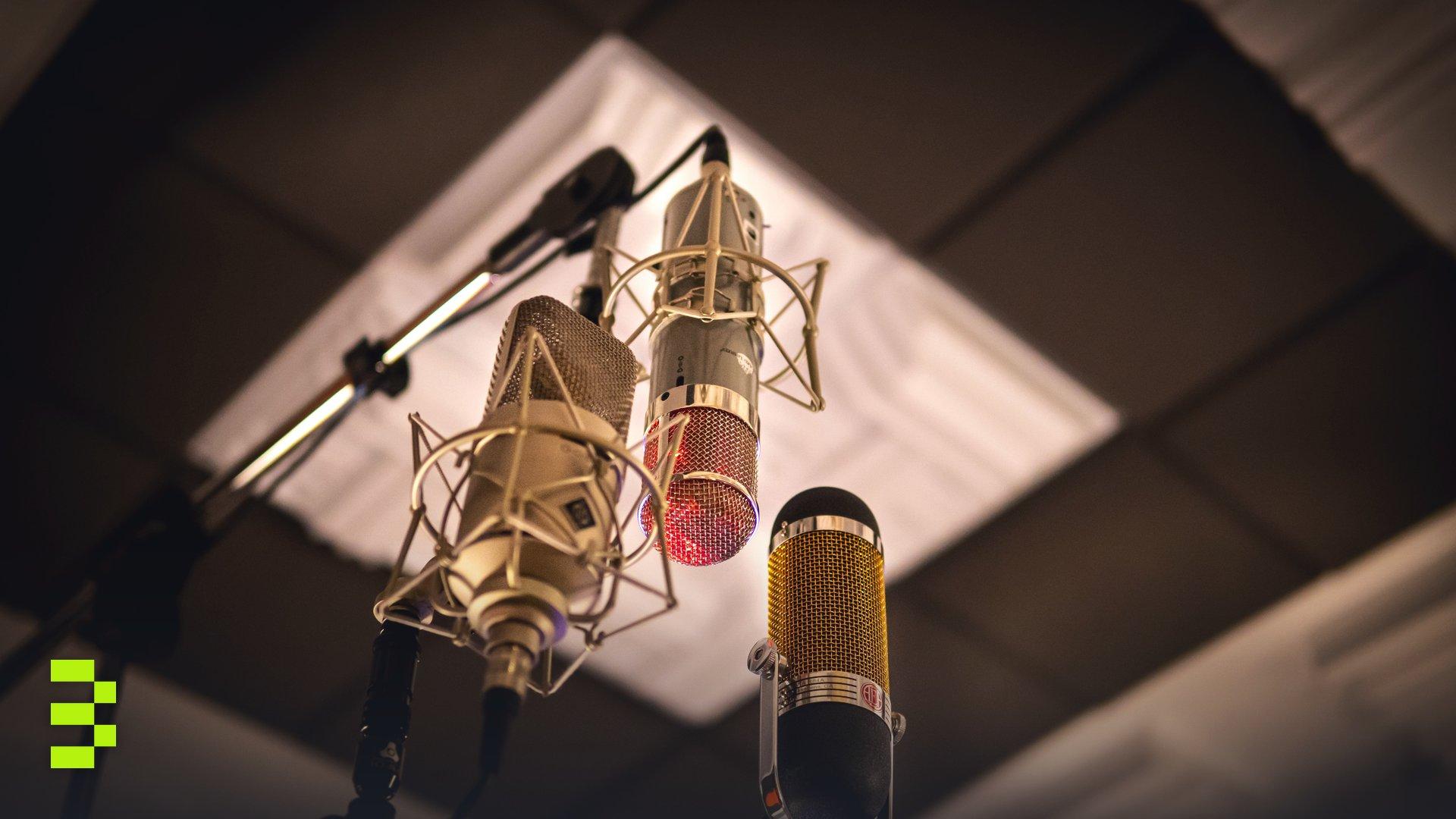 Three condenser microphones arranged for optimal sound capture in a recording studio.