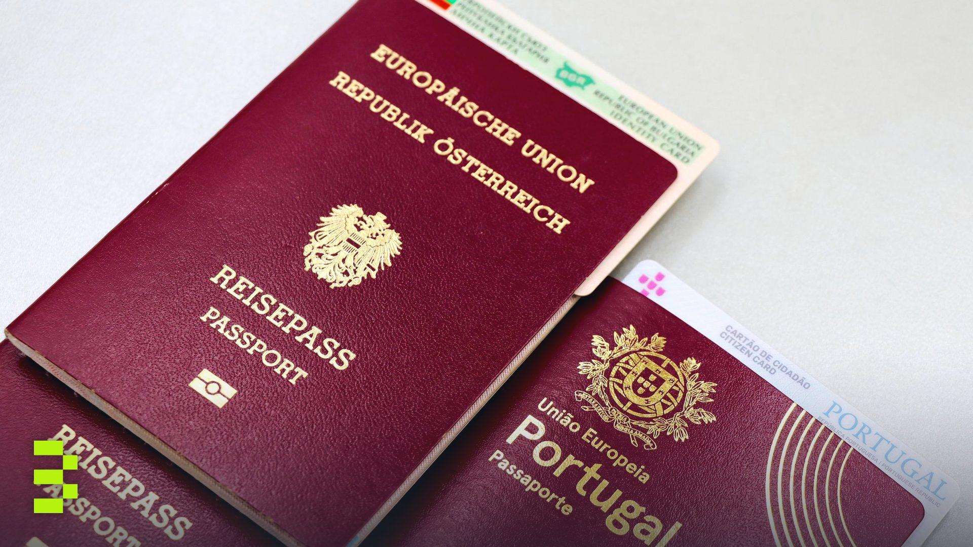 A close-up image of Austrian and Portuguese passports with a Bulgarian ID card.