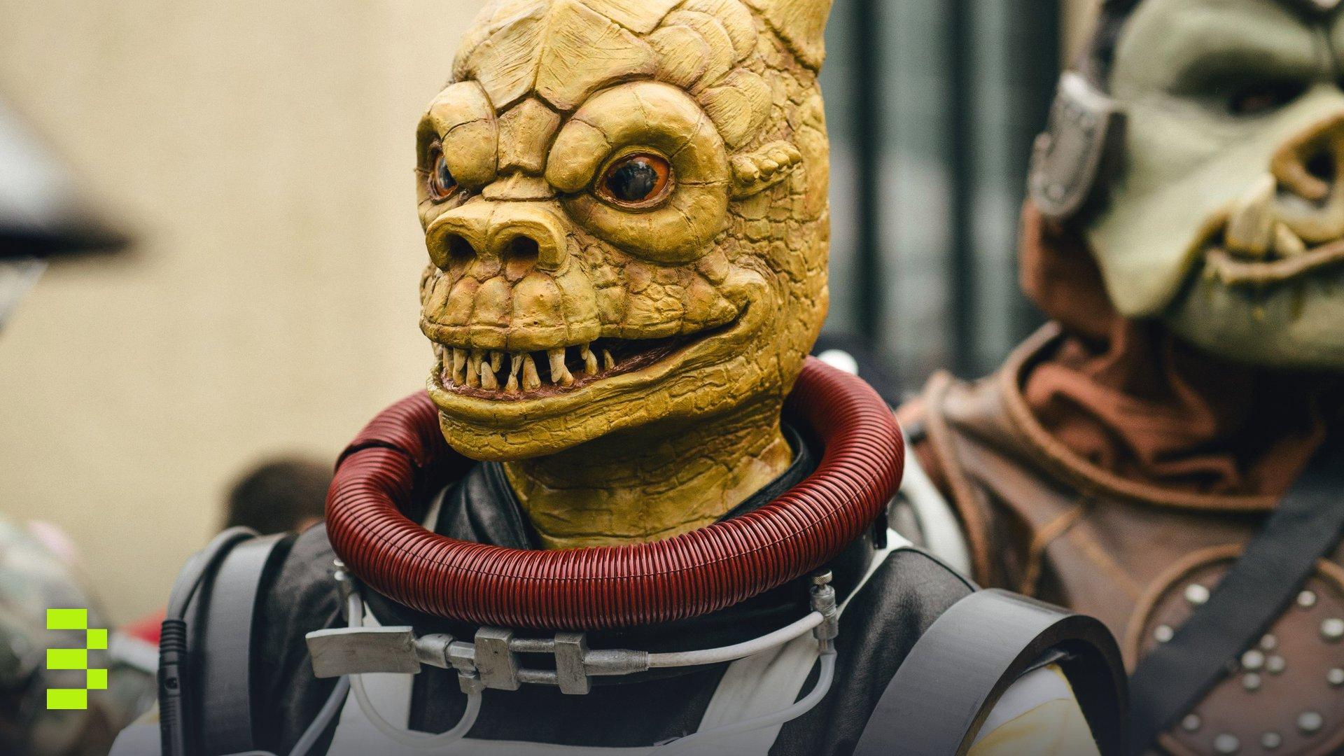 Close-up of cosplayers in alien costumes at a sci-fi convention.