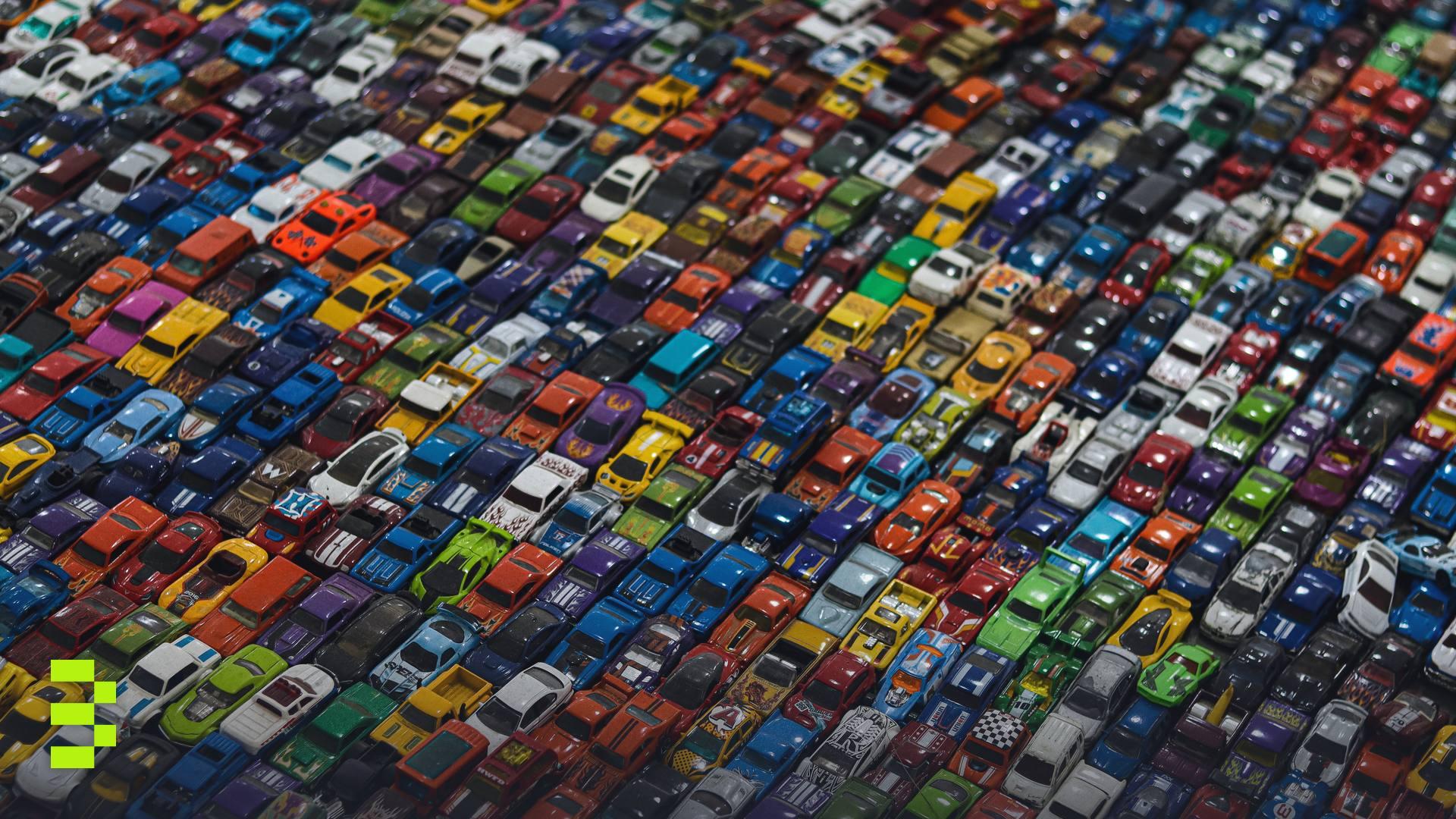 A dense, colorful mosaic of multicolored toy cars.