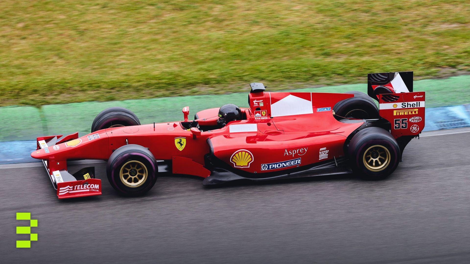 High-speed Formula 1 car in action on an outdoor racing track.
