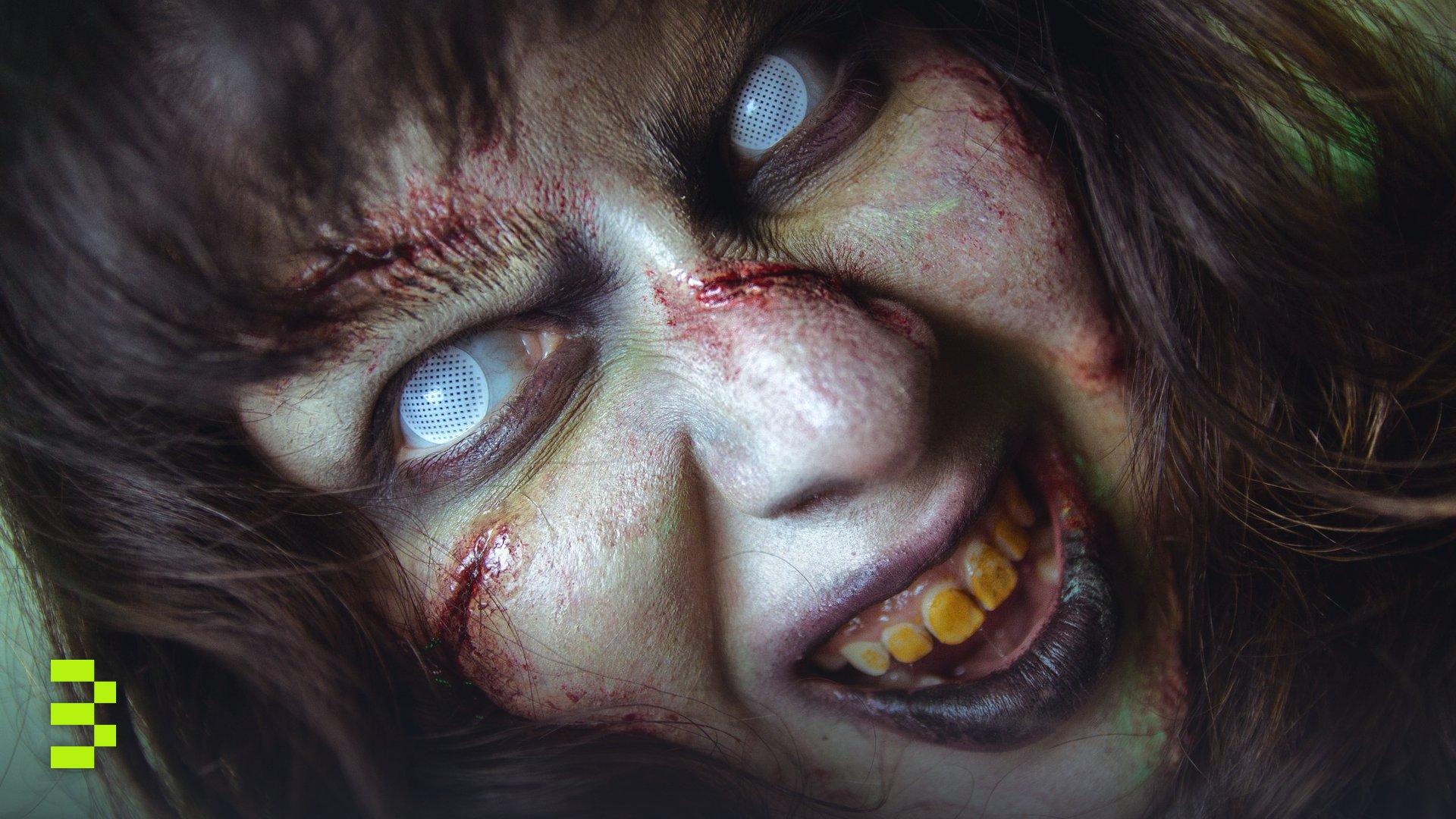 Close-up of a zombie with white eyes and gory makeup.