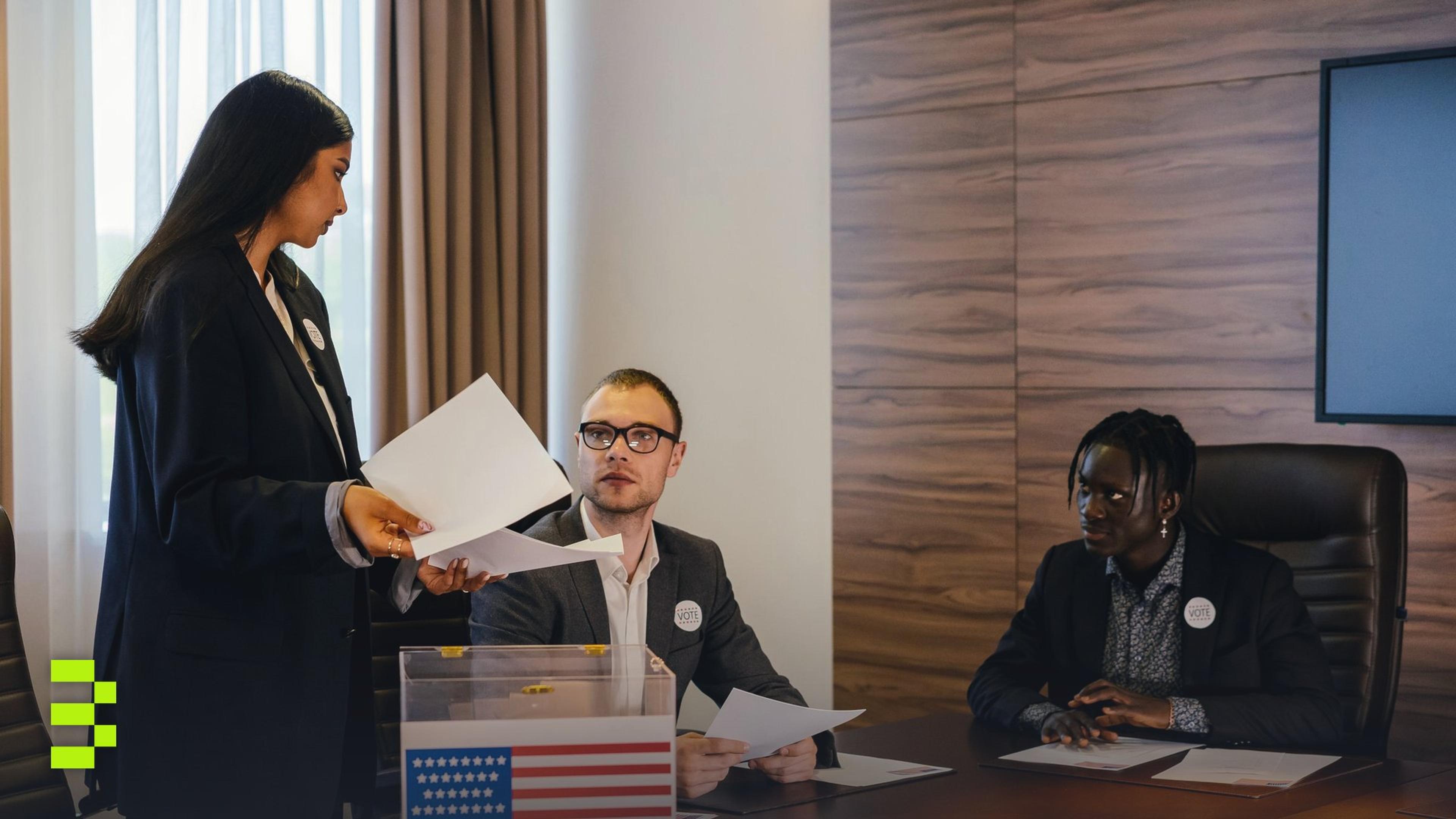 A group of professionals talking around a conference room table.