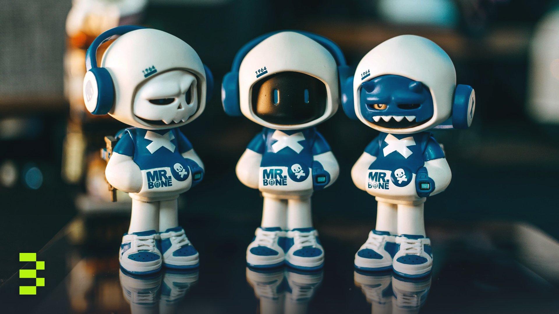 Three toy figures wearing blue and white costumes with headphones, labeled Mr. Bone.
