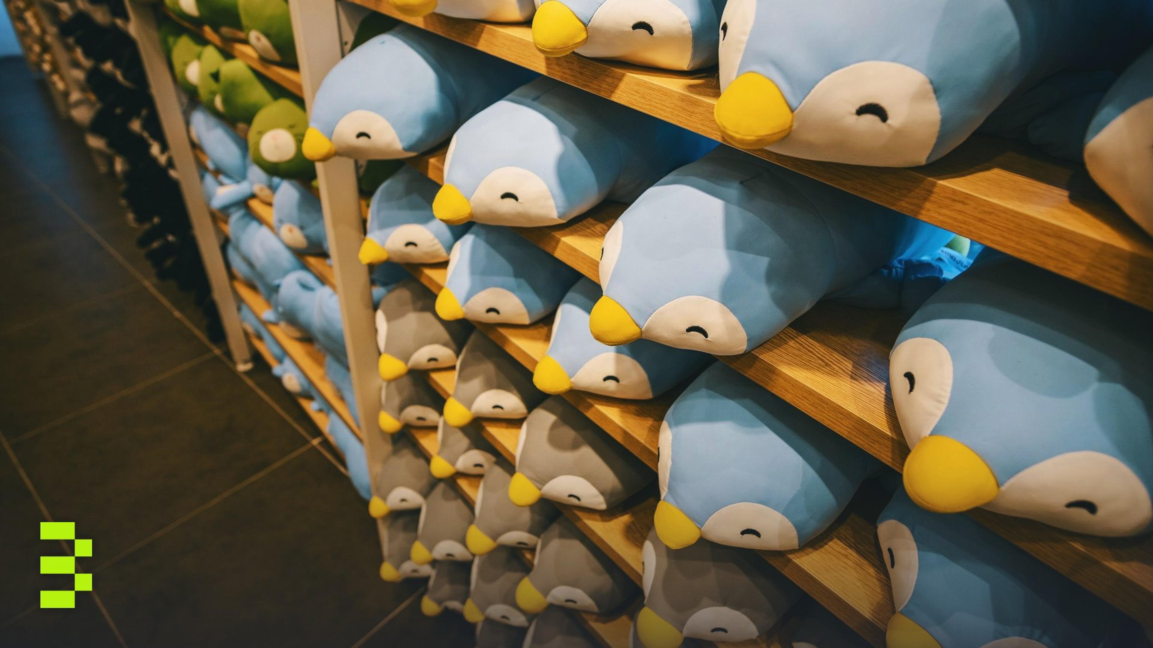 Rows of adorable penguin plush toys on wooden shelves.