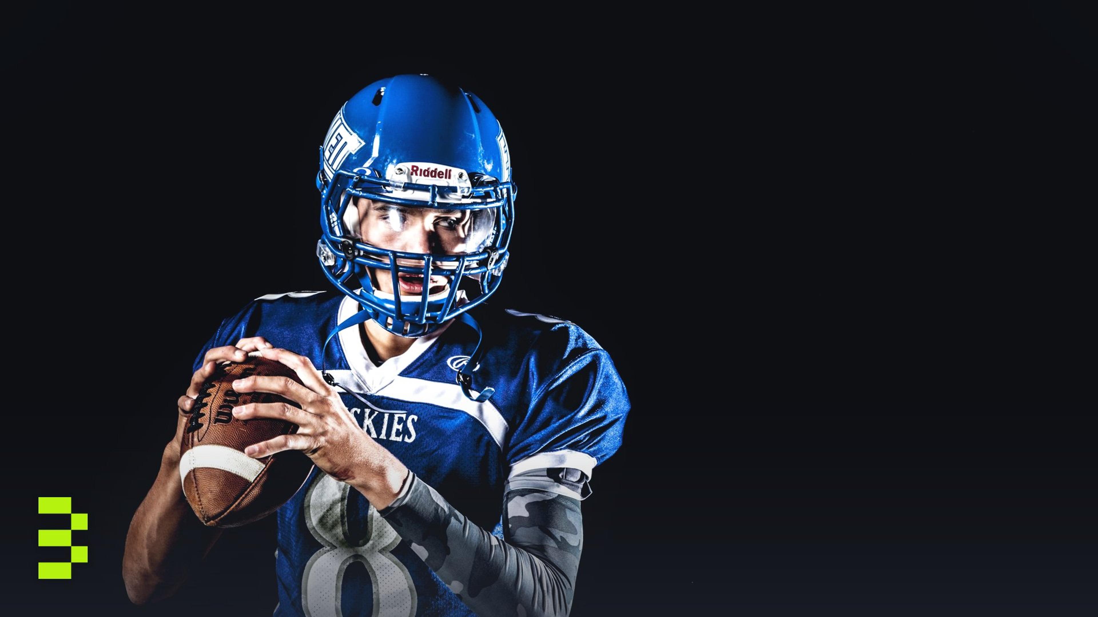 A focused American football quarterback poised to throw during a game.
