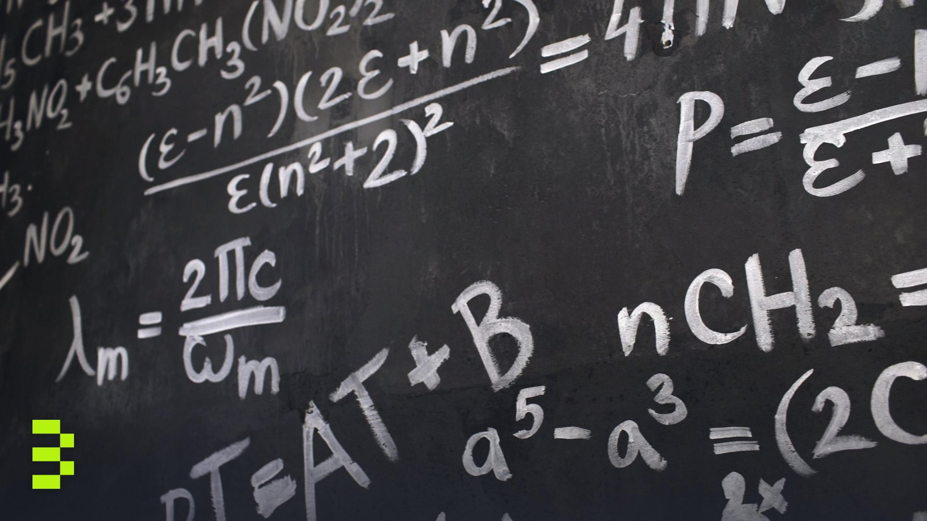 Close-up of a dark chalkboard covered in handwritten white math and chemistry equations, including fractions and Greek letters