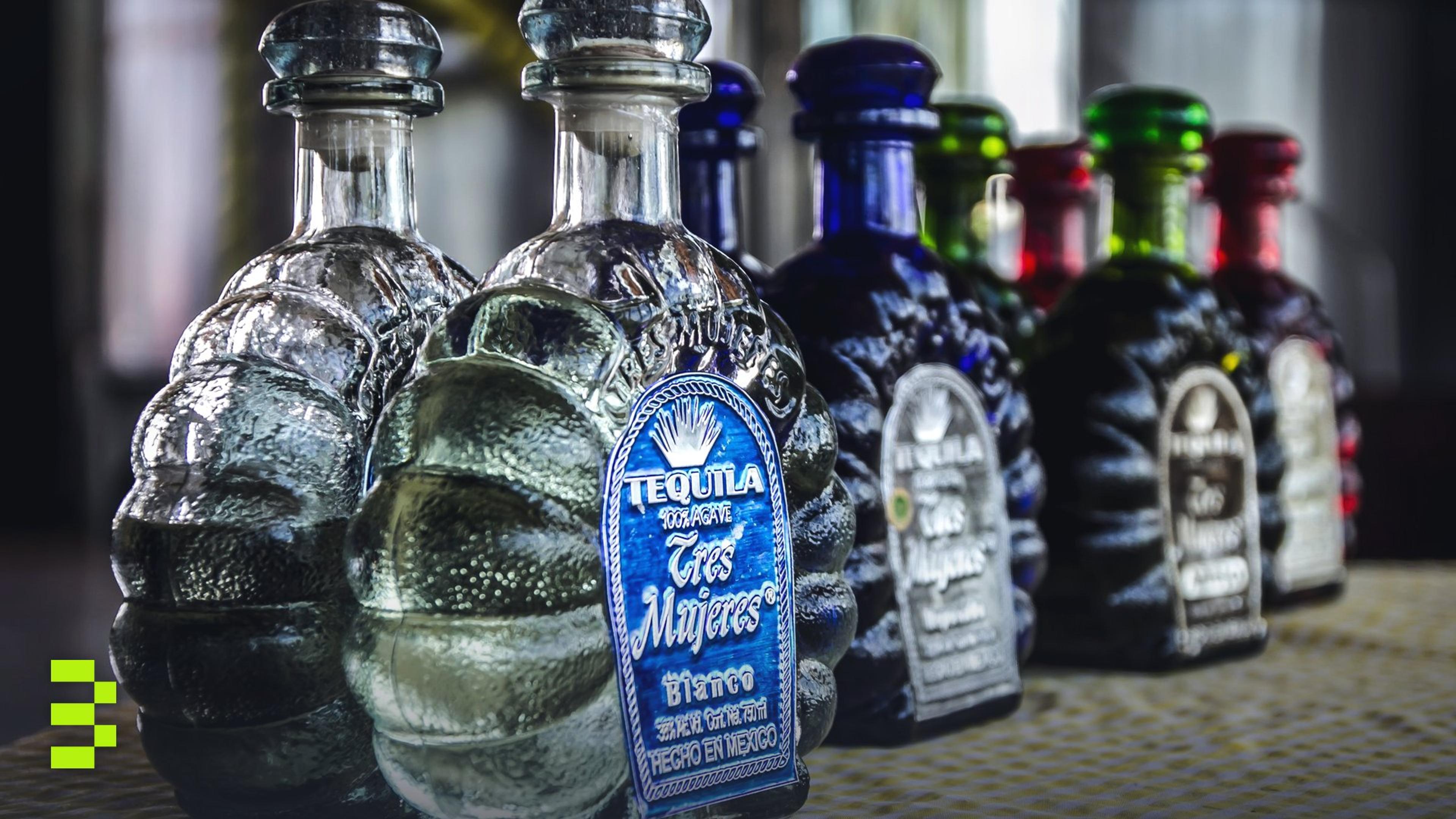 Colorful tequila bottles arranged in a row.