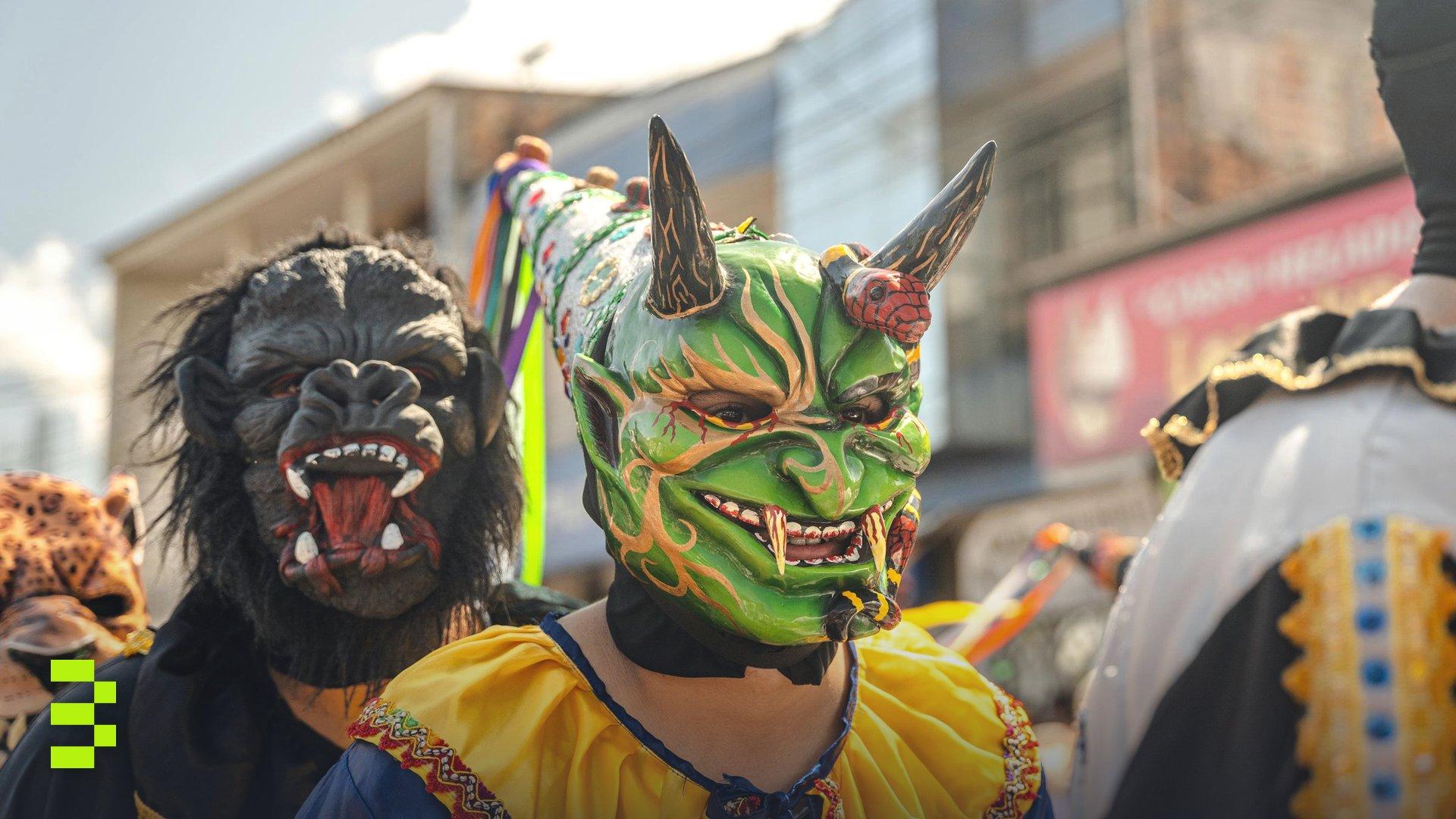 Vibrant costumes and masks at a festive parade in Rioja, Peru.
