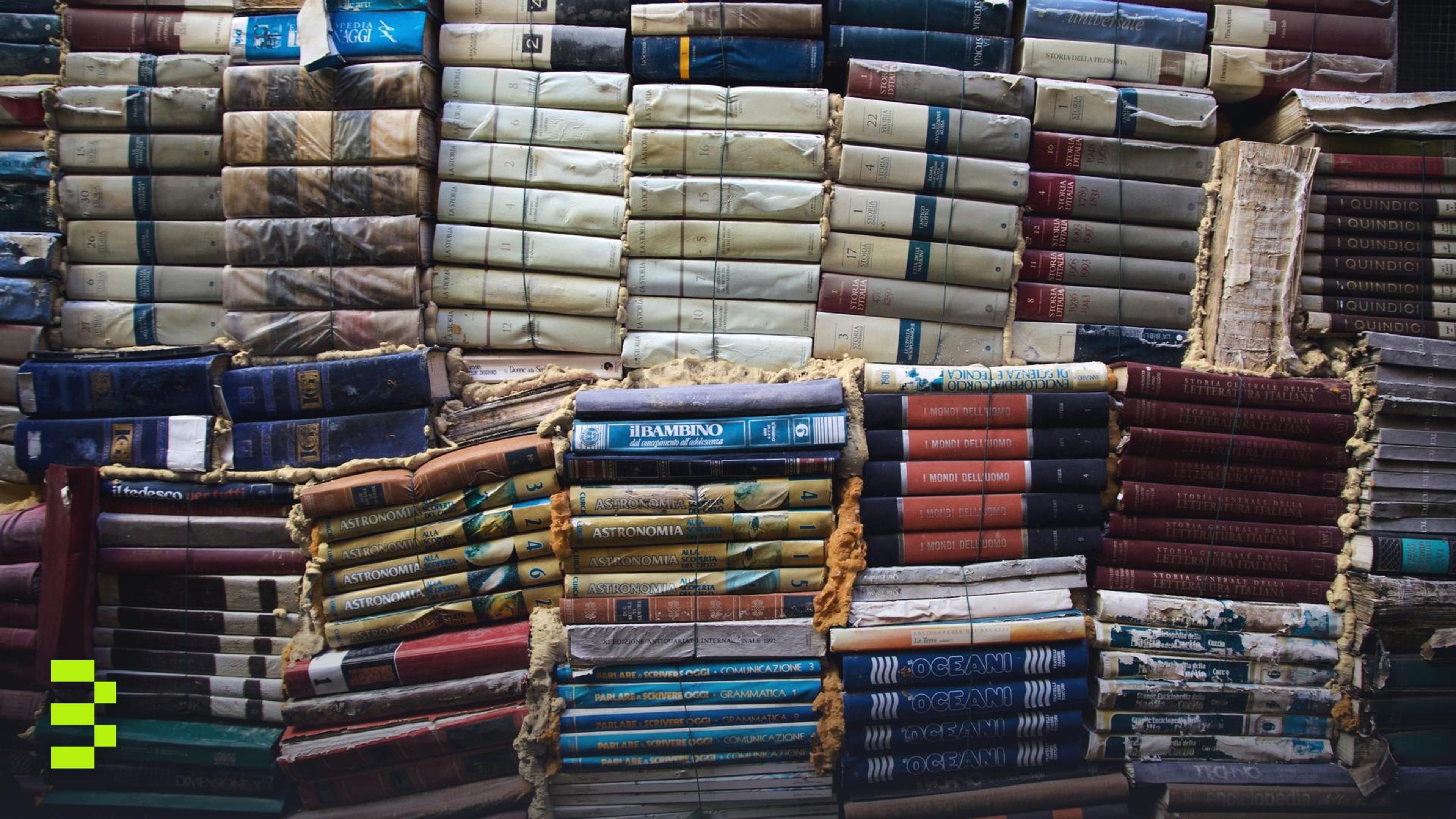 A creative display of vintage books stacked in various colors.
