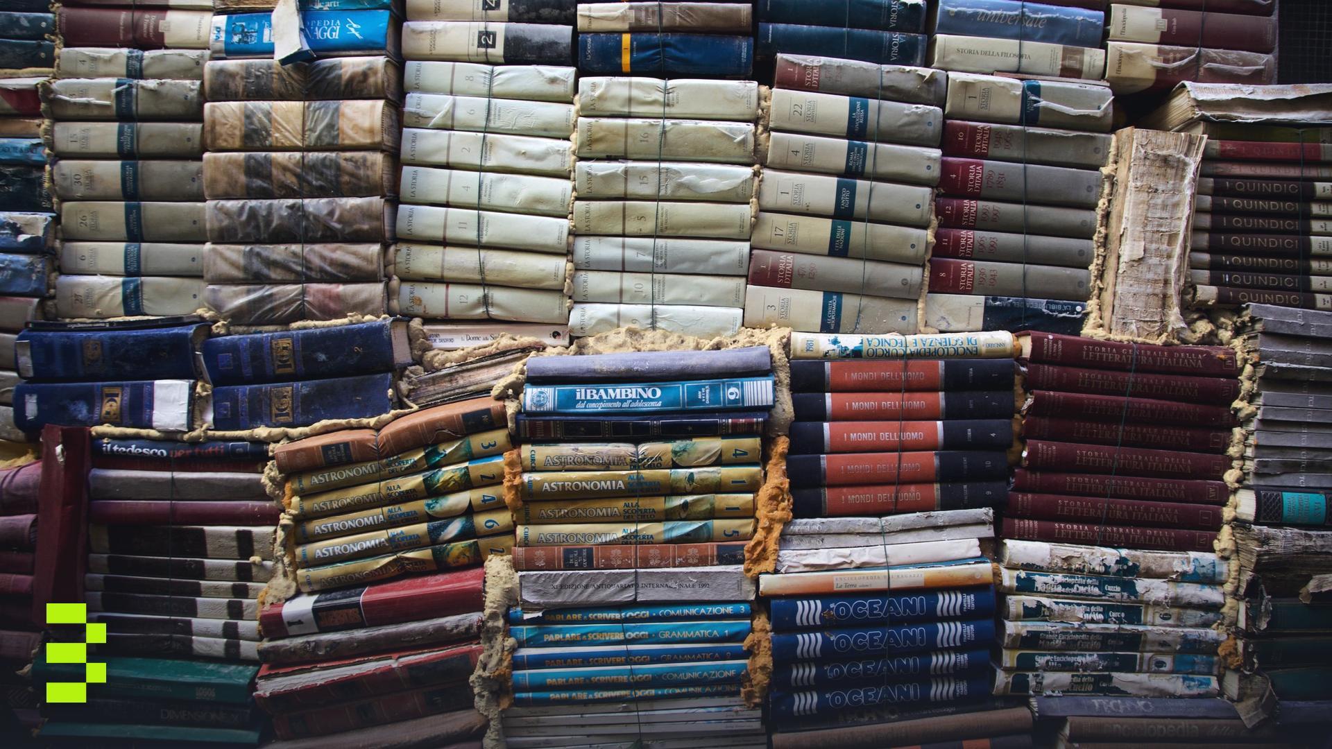 A creative display of vintage books stacked in various colors.