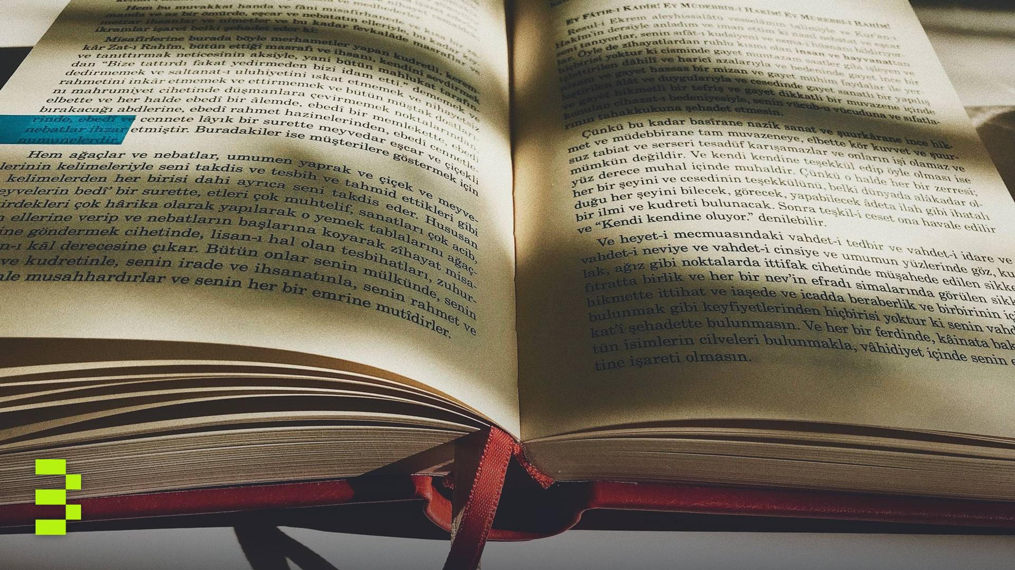 An open book with visible text and shadows.