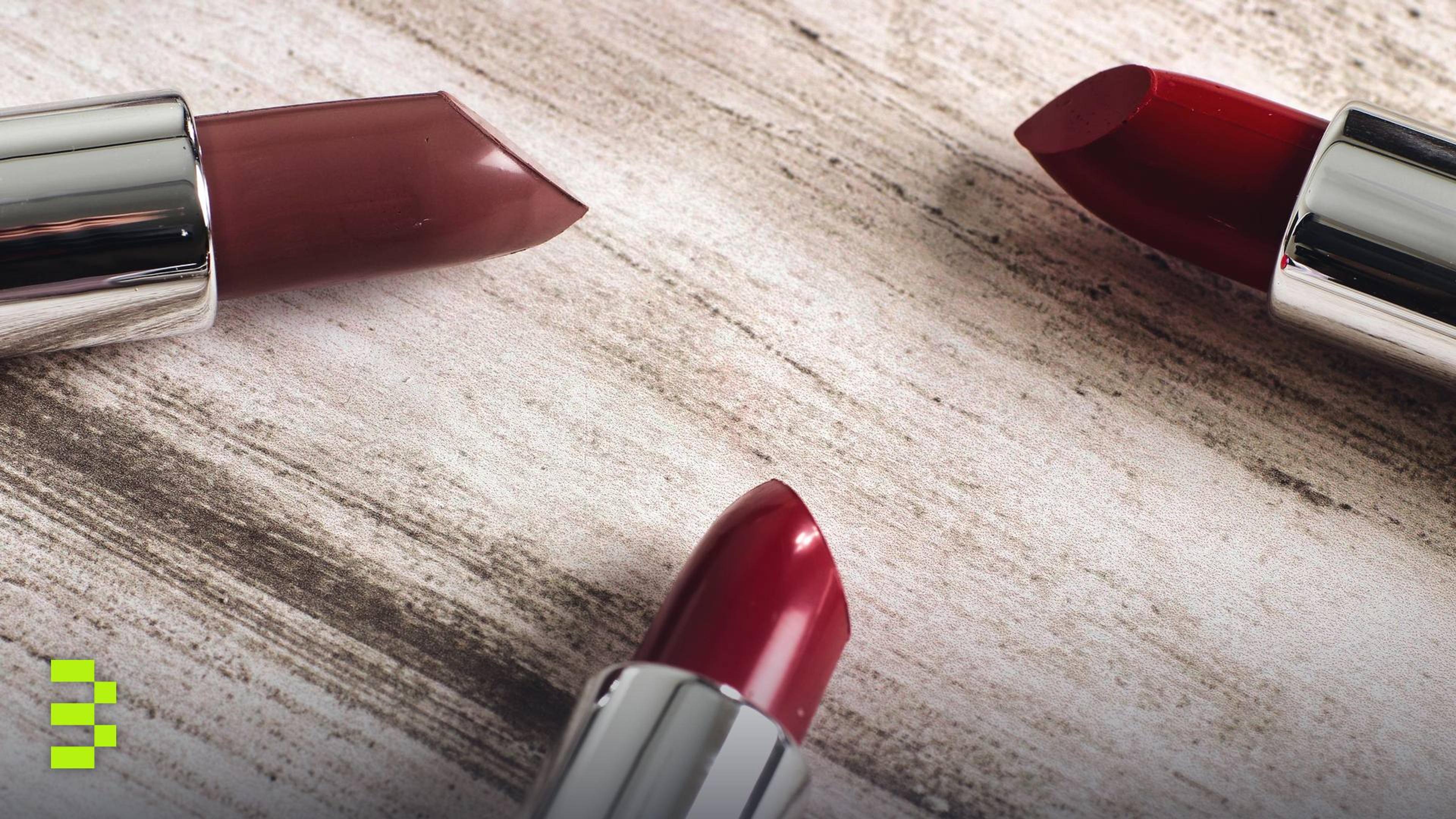 Close-up of lipsticks arranged artistically on a rustic wooden background.
