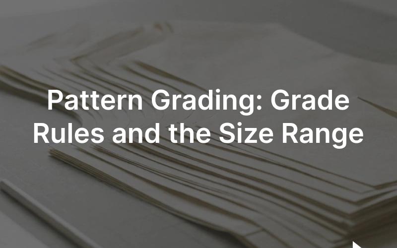 Pattern grading: a nest of graded garment pattern pieces overlaid in multiple sizes on a cutting table