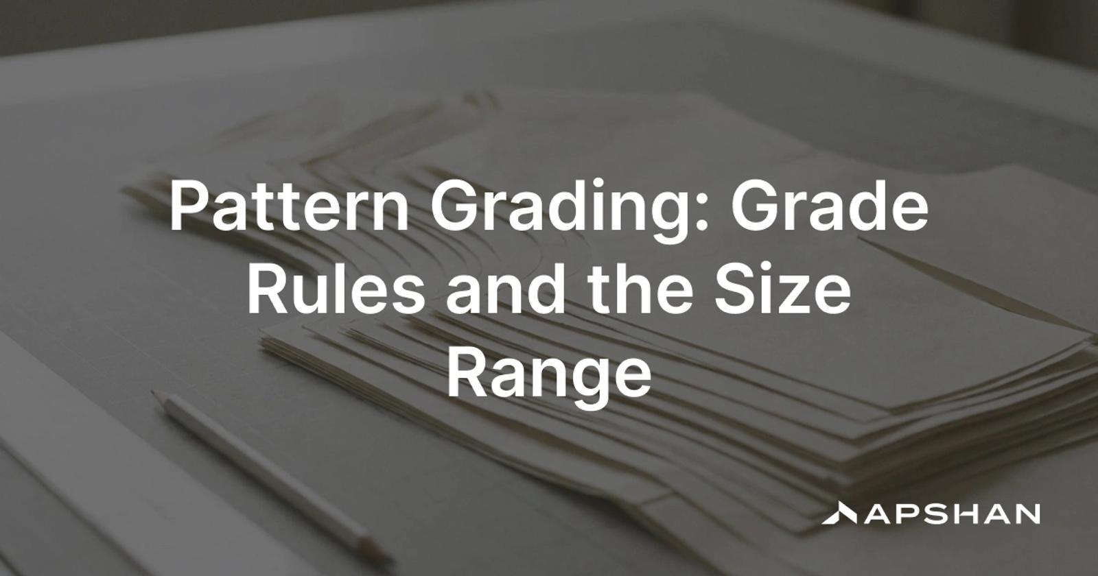 Pattern grading: a nest of graded garment pattern pieces overlaid in multiple sizes on a cutting table
