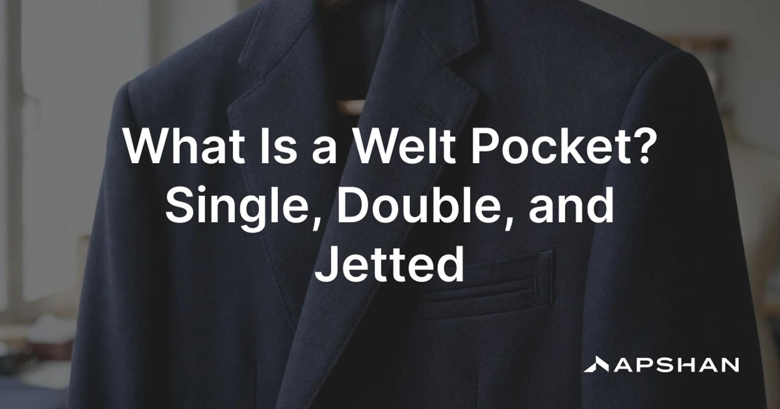 Close-up of a tailored jacket with a single-welt breast pocket and a double-welt jetted hip pocket set cleanly into the wool
