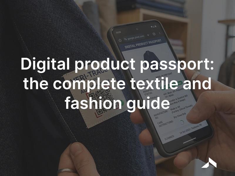 A woven garment label with a QR code being scanned by a phone, opening the garment's digital product passport.