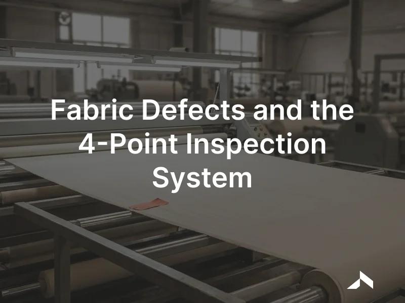 A fabric inspection machine unrolling woven cloth under bright light with an inspector marking defects