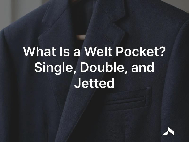 Close-up of a tailored jacket with a single-welt breast pocket and a double-welt jetted hip pocket set cleanly into the wool